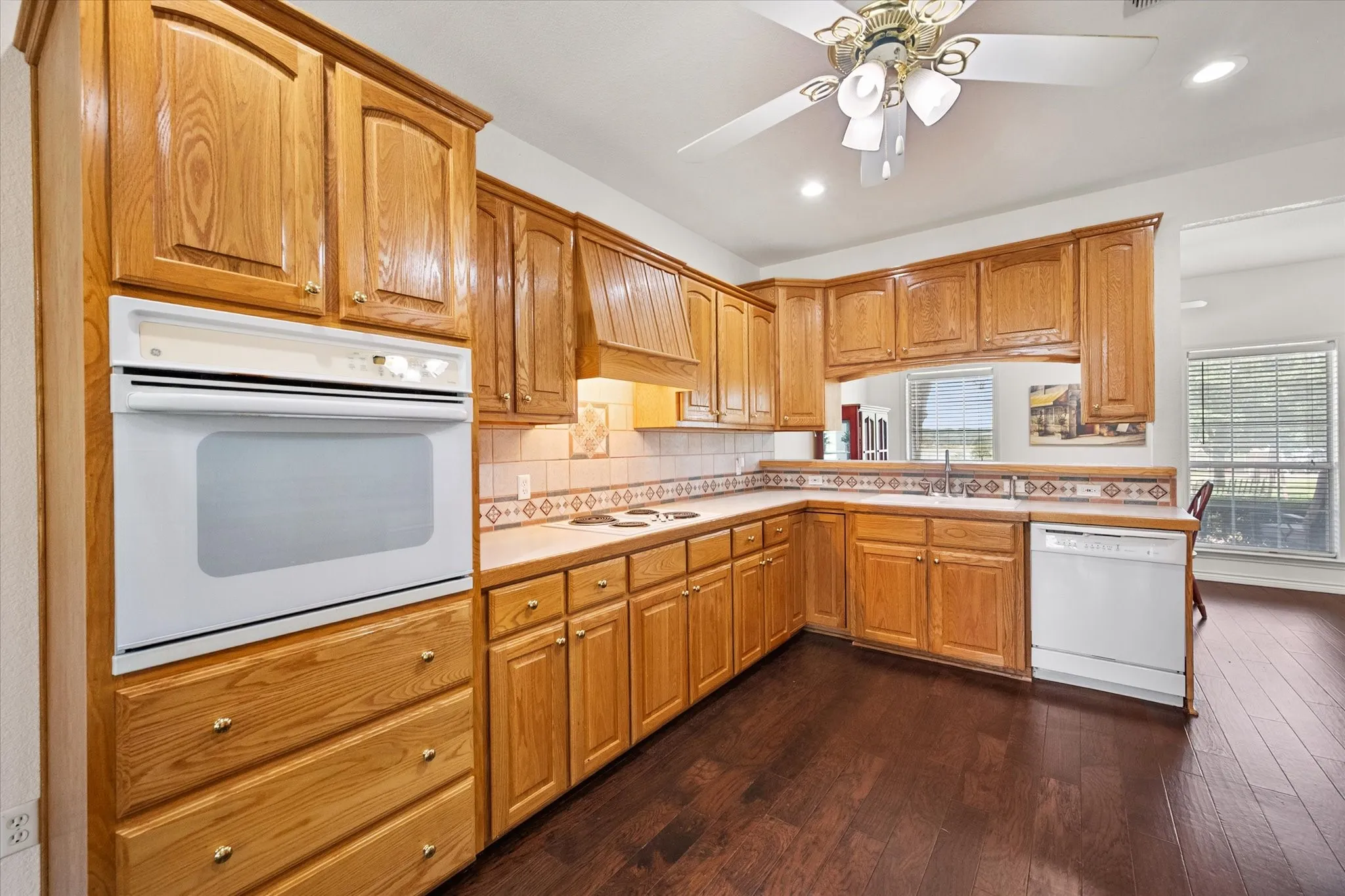 Spacious kitchen near Richland Chambers Lake with wood cabinetry, tile backsplash, and plenty of counter space.