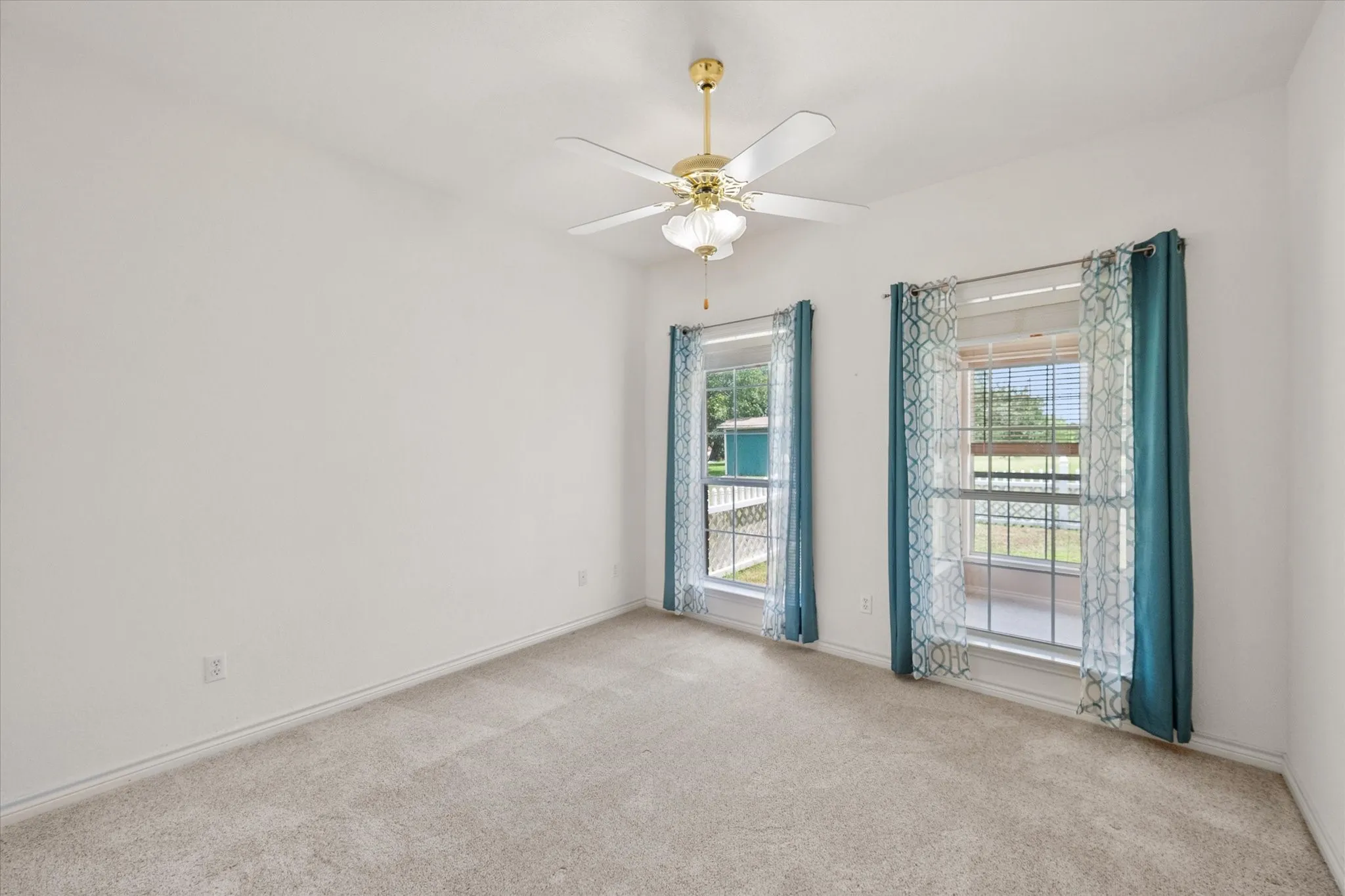 Spacious secondary bedroom in Streetman, TX with carpet, ceiling fan, and flexible layout for guests or family.