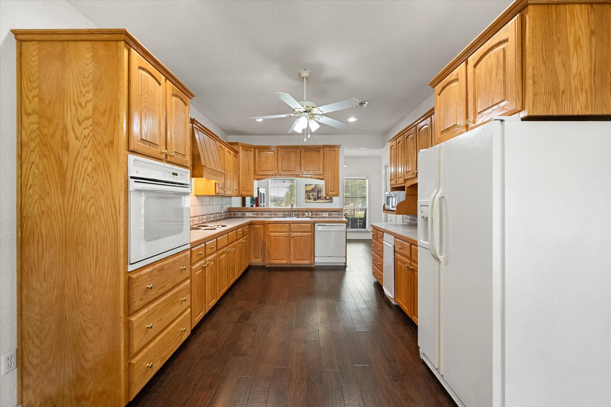 Large kitchen in Streetman, TX with generous cabinet storage, appliances, and easy access to the breakfast area.