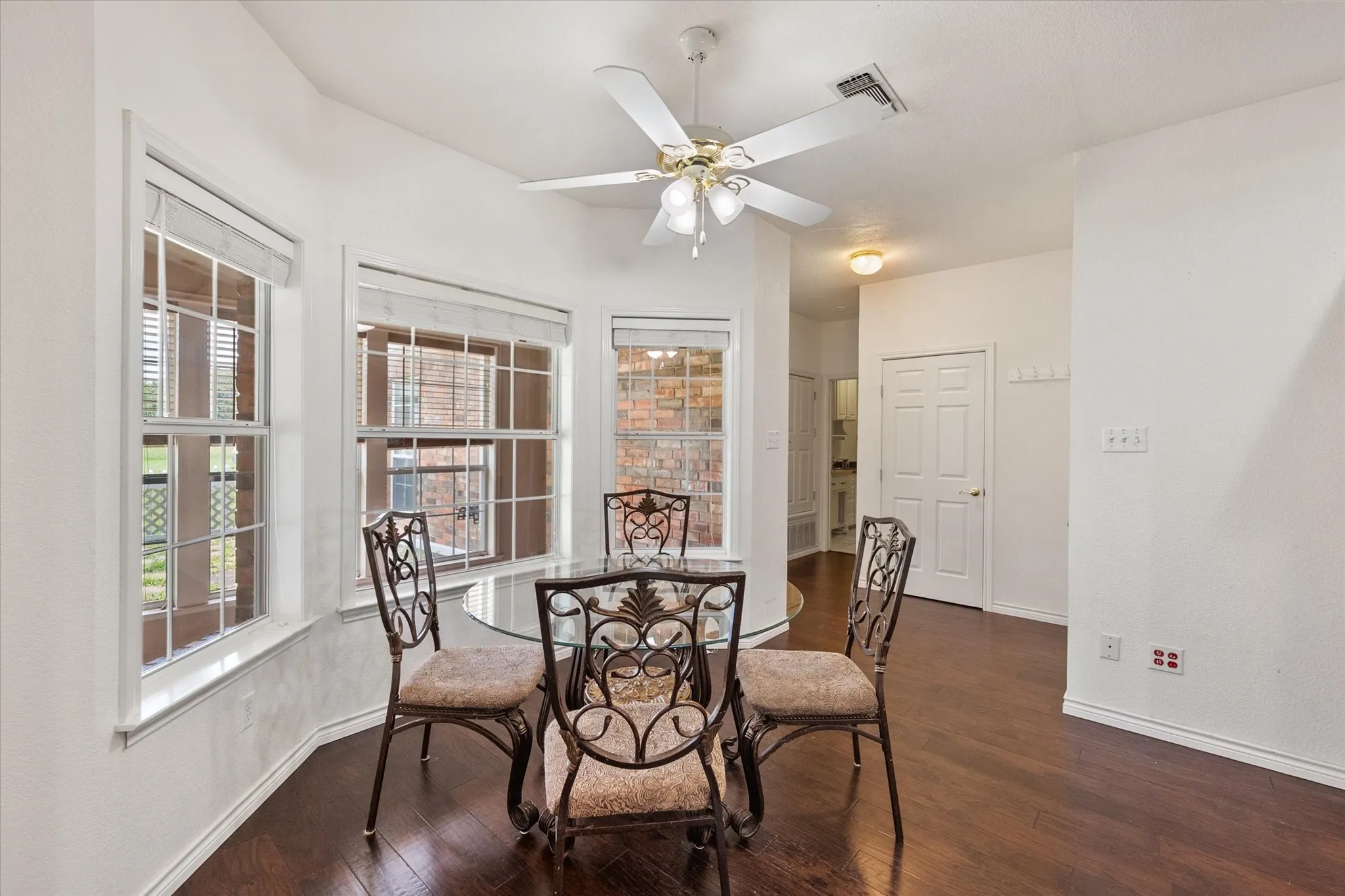 Breakfast area near Dallas with natural light, wood flooring, and convenient access to nearby living and kitchen spaces.