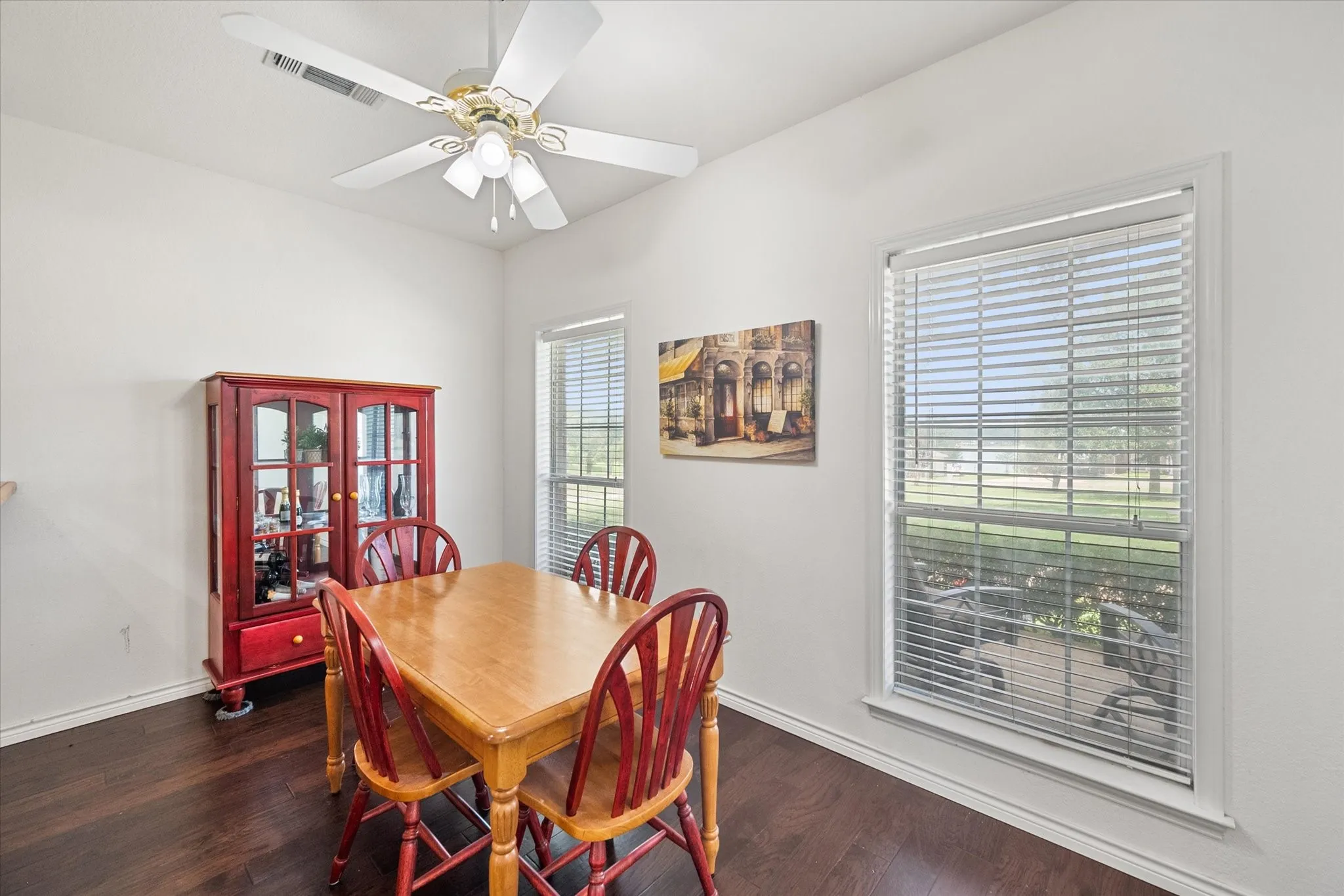 Comfortable dining room near Richland Chambers Lake with large windows, wood flooring, and space for gatherings.