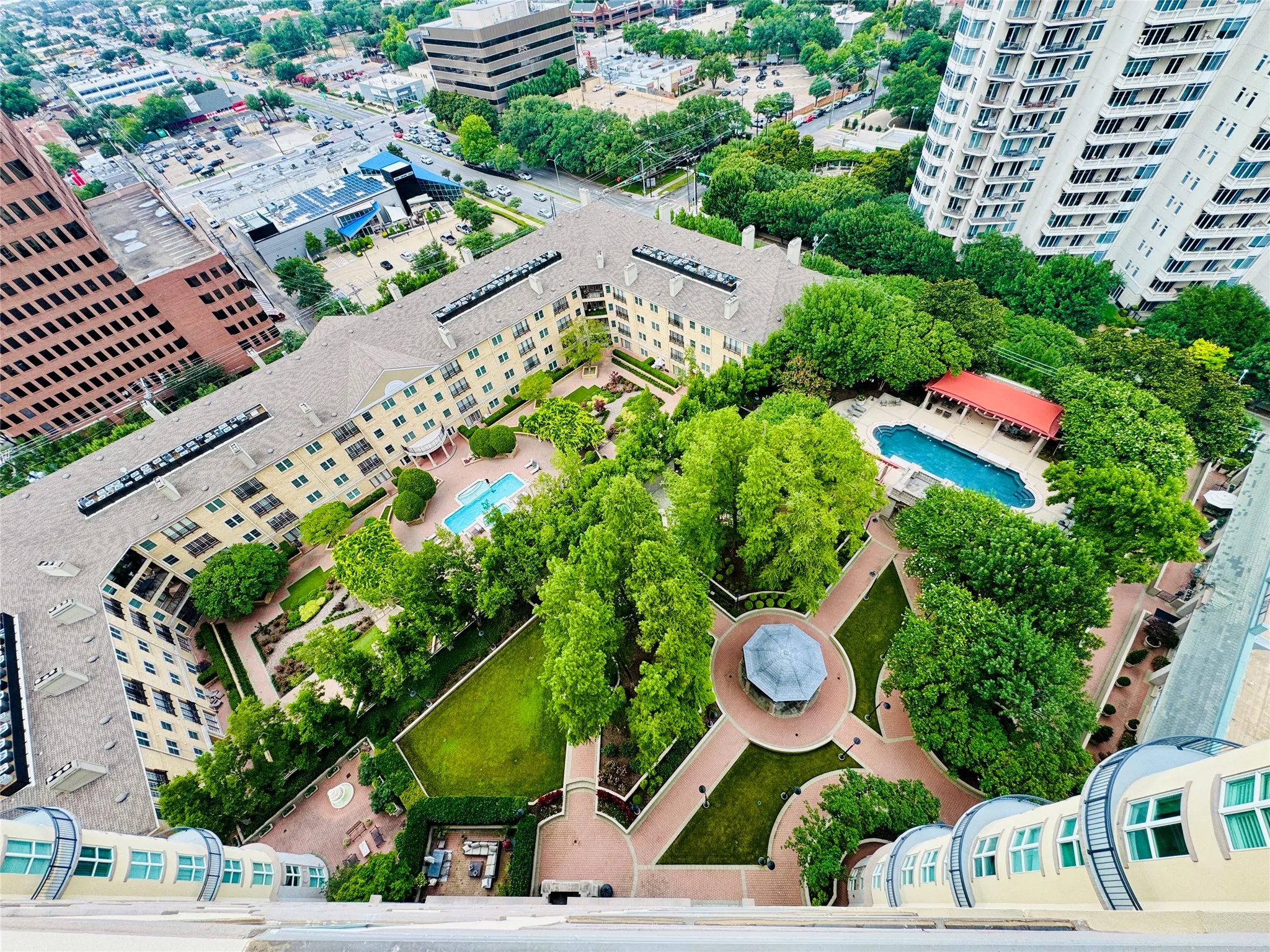 View from Balcony-Terrace. The aerial view of The Grounds... and pool which is the one on the right.