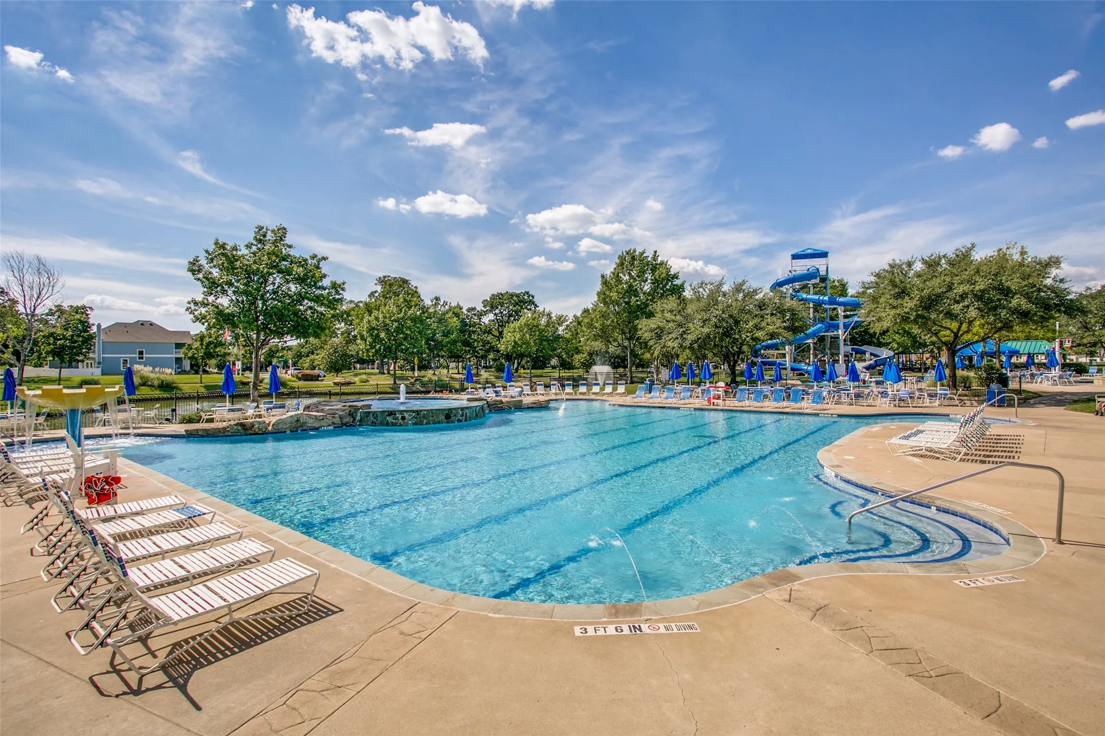 Expansive aquatic amenity featuring a large swimming pool with lane lines and integrated steps