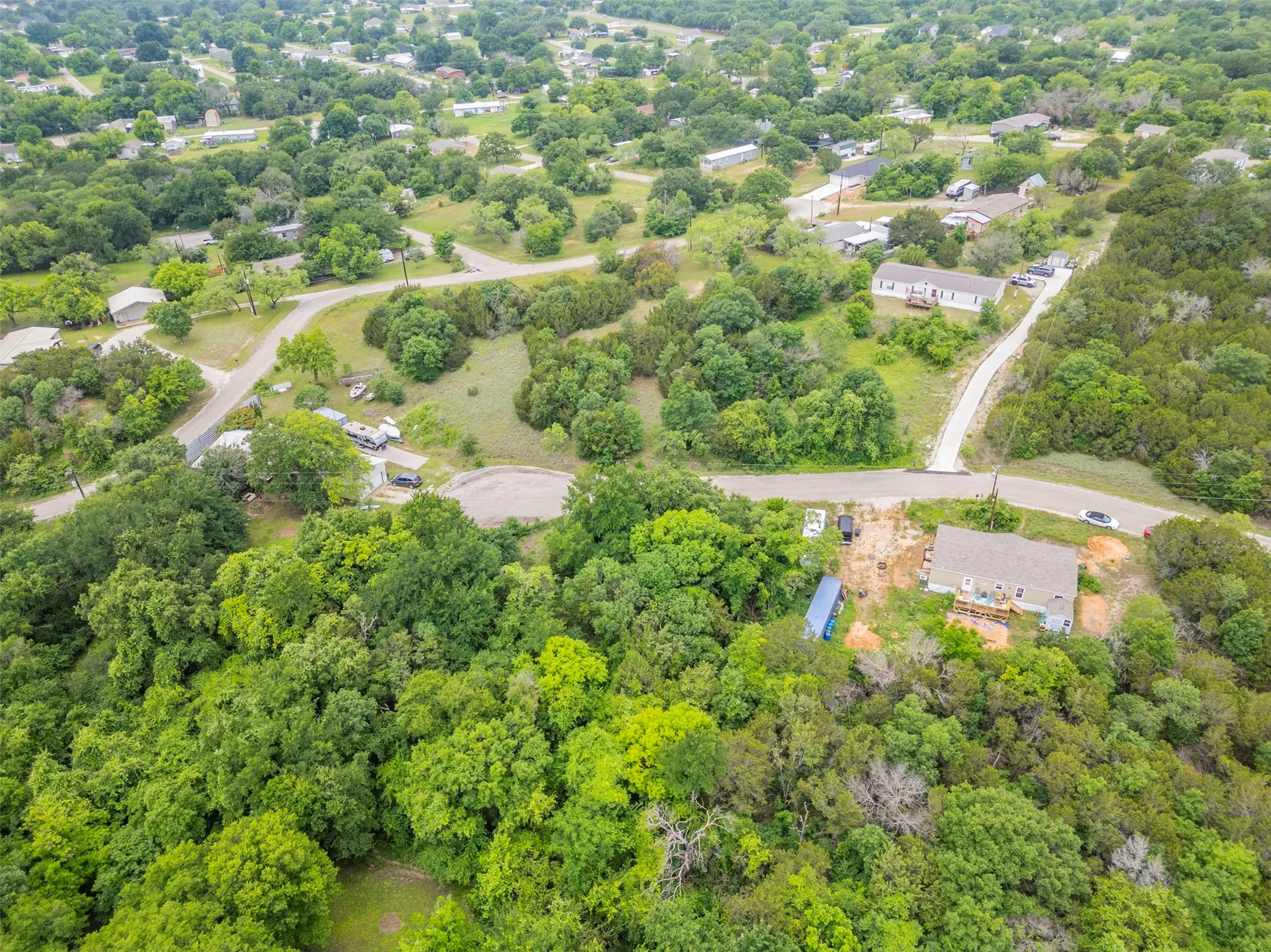 Extensive treed landscape featuring multiple dwellings and natural terrain
