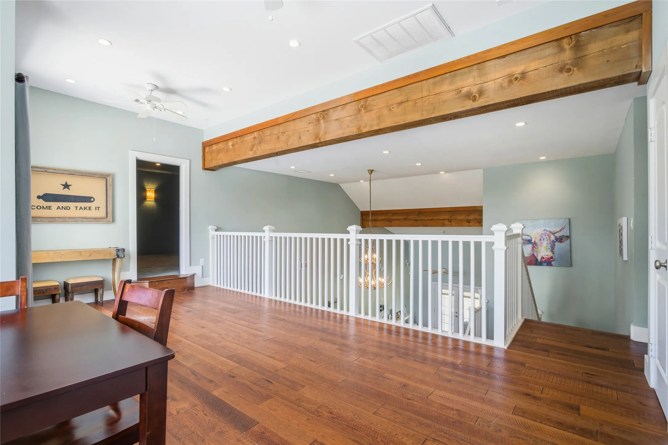 At the top of the stairs, a large loft area serves as another open gathering area.