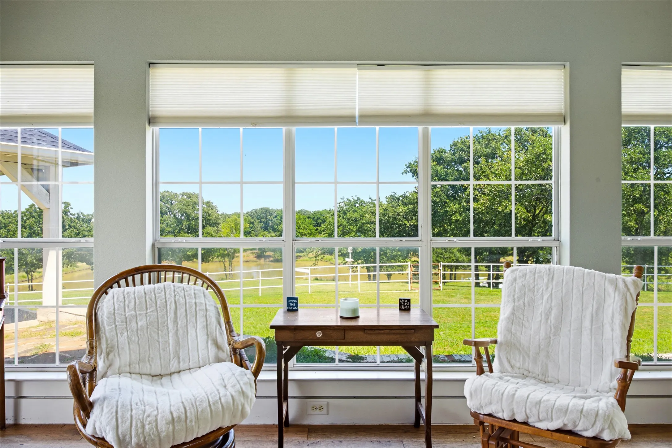 And to finish the primary bedroom, there is a large sunroom with a wall of glass windows looking out to the big pond and the large backyard.  A door opens out to the back porch or just stay inside and enjoy the view.