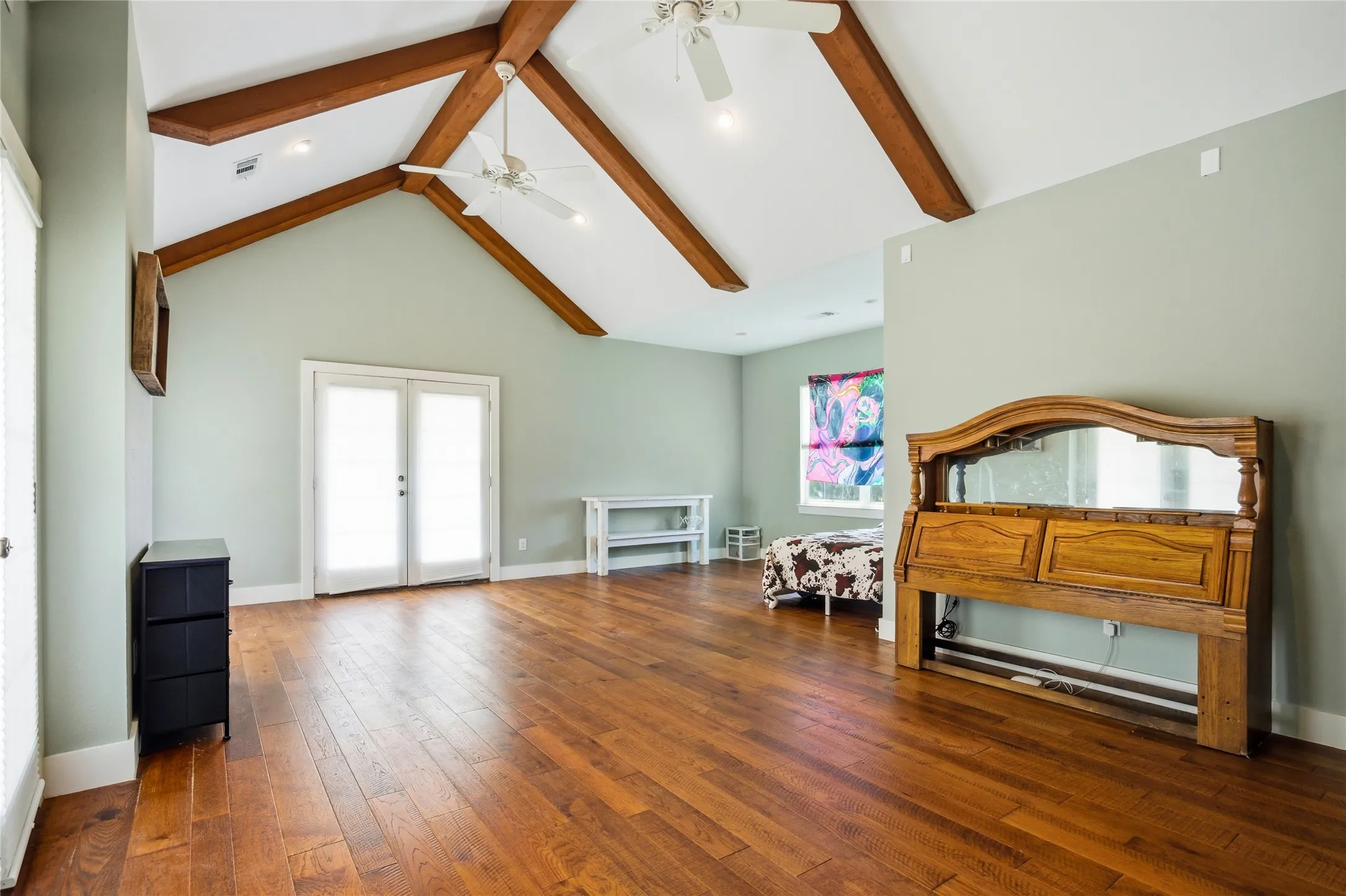 Bedroom 3 is a huge room that has two usable spaces for beds and dressers.  Double doors on each side lead out to a wrap-around balcony with gorgeous view.  It's a great place to sit and relax in the serenity of this property.