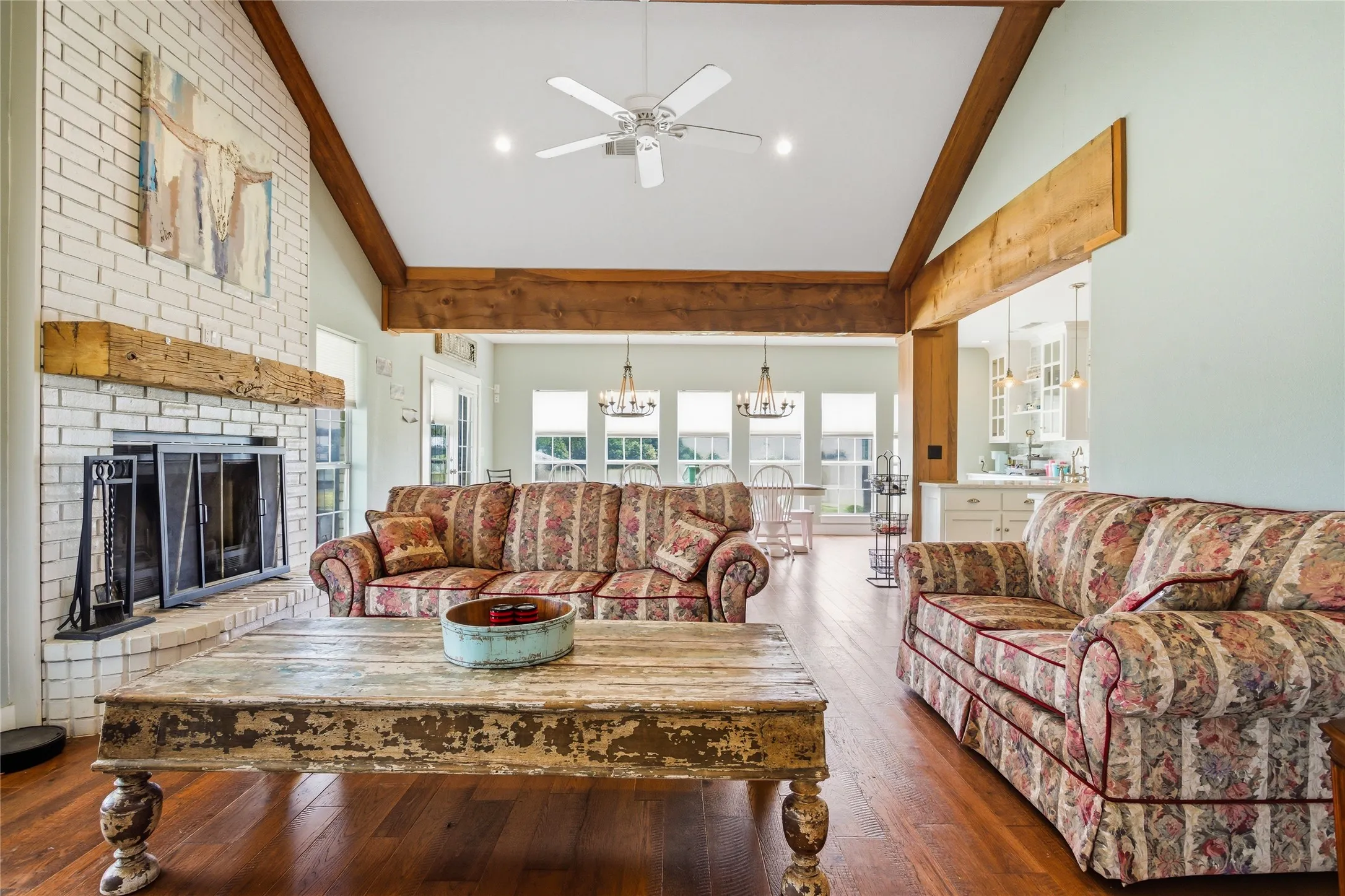 An open living joins the two sides of the home.  A fireplace and gorgeous wood accents give the room a comfortable feeling.