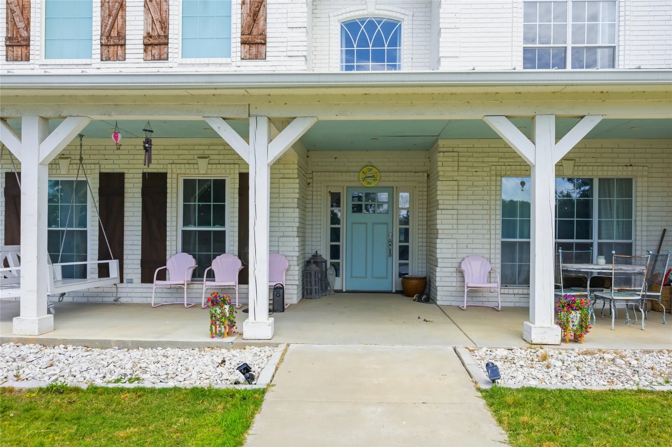 Greeting you as you walk to the home, a big covered porch with  chairs calls to come in, sit as spell, and enjoy the serene nature of the land aroudn you,
