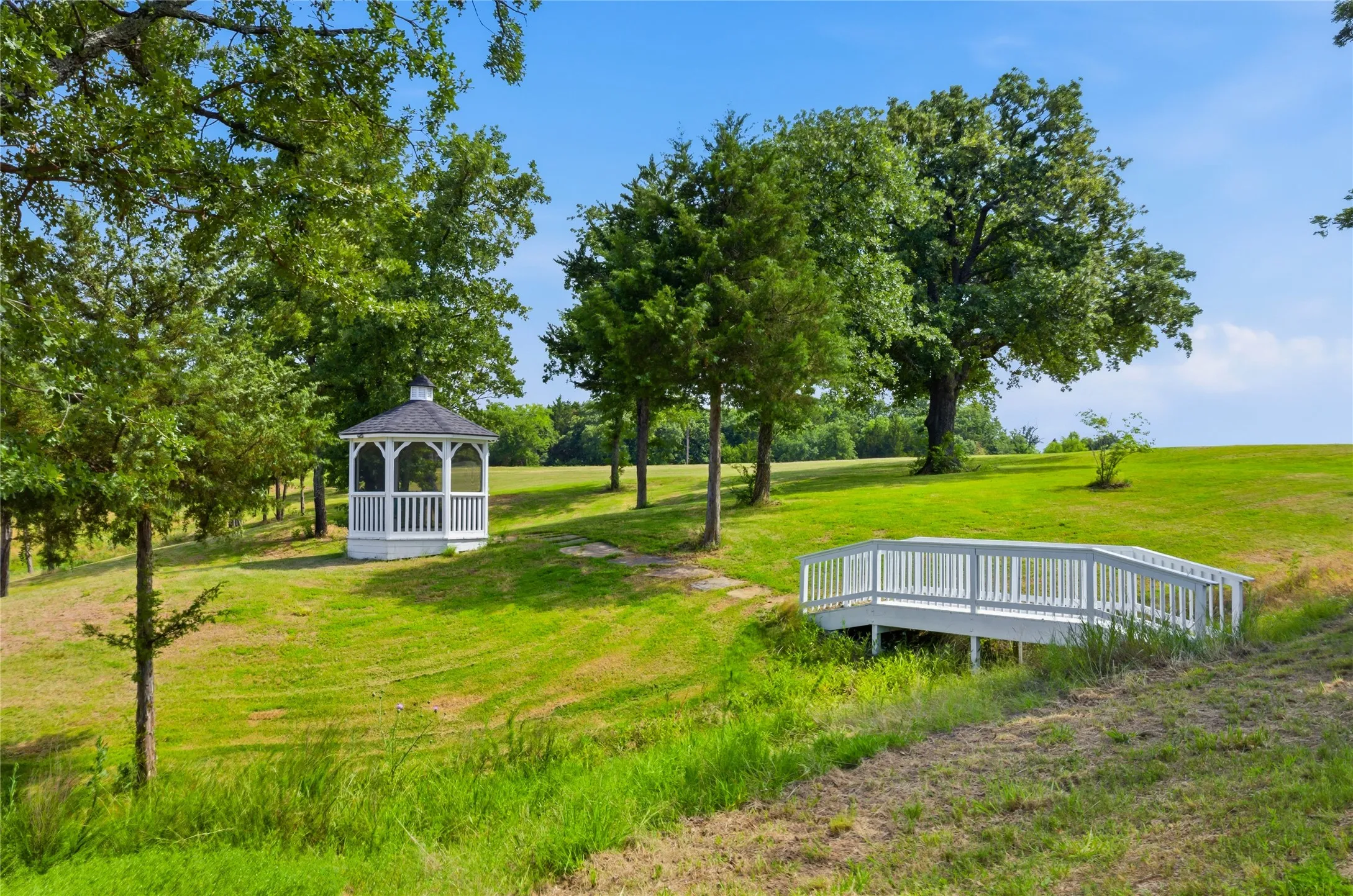 You  will see little bridges built out on the walking path on both sides of the road.  This gazebo is a nice short destination when walking.
