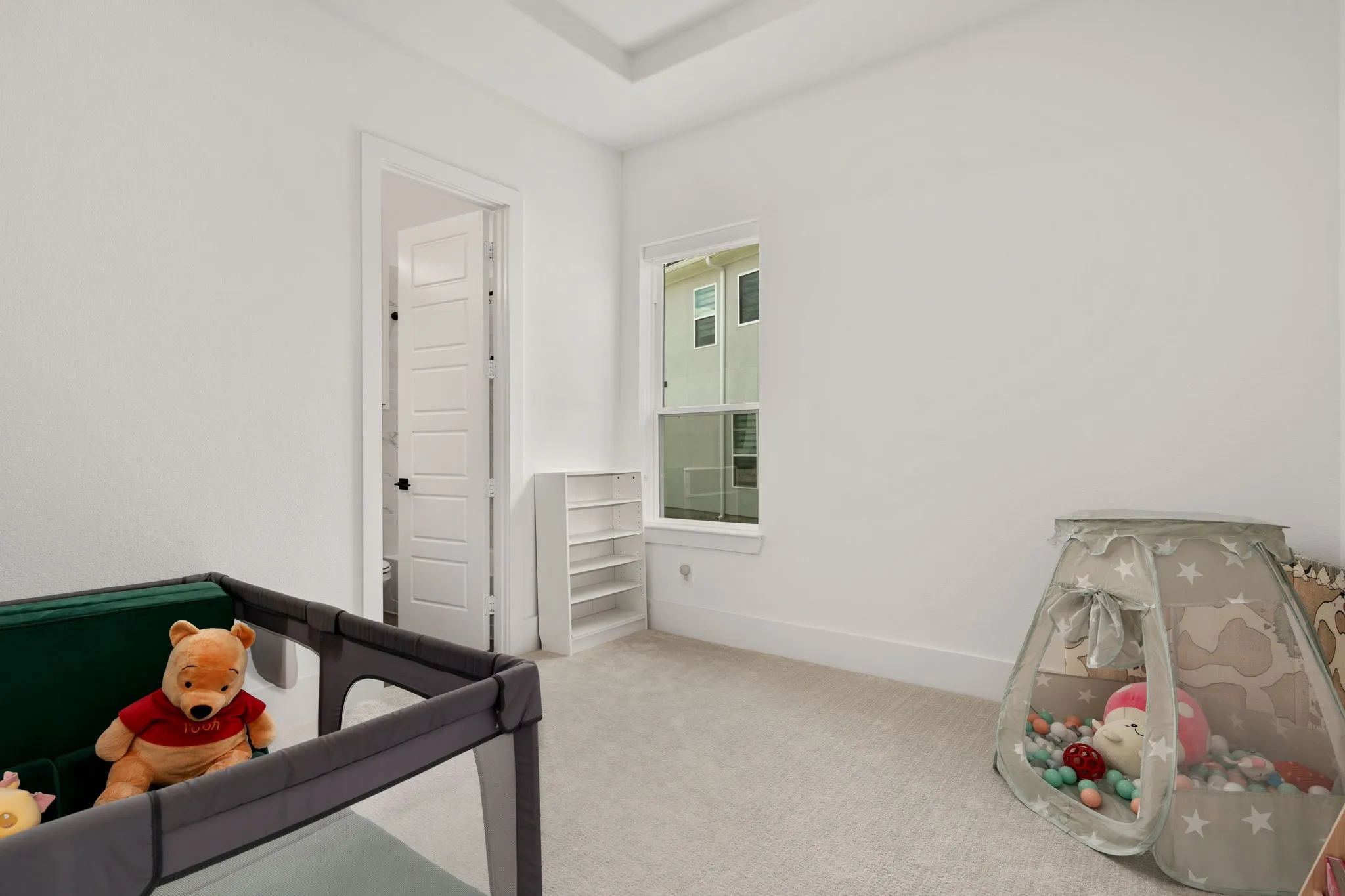 Bedroom featuring light-colored carpeting and white walls