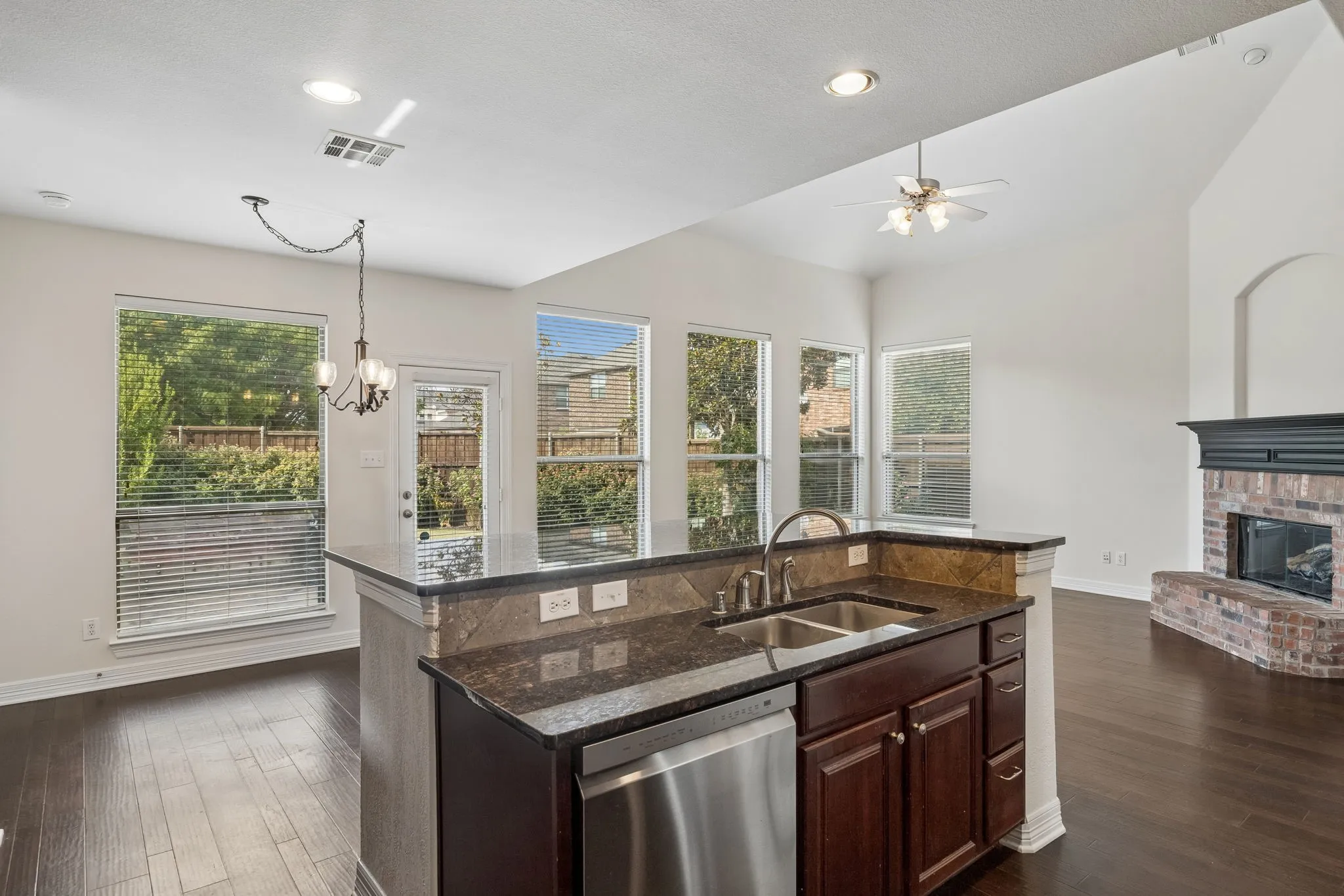 Kitchen island with a double basin sink and stainless steel dishwasher