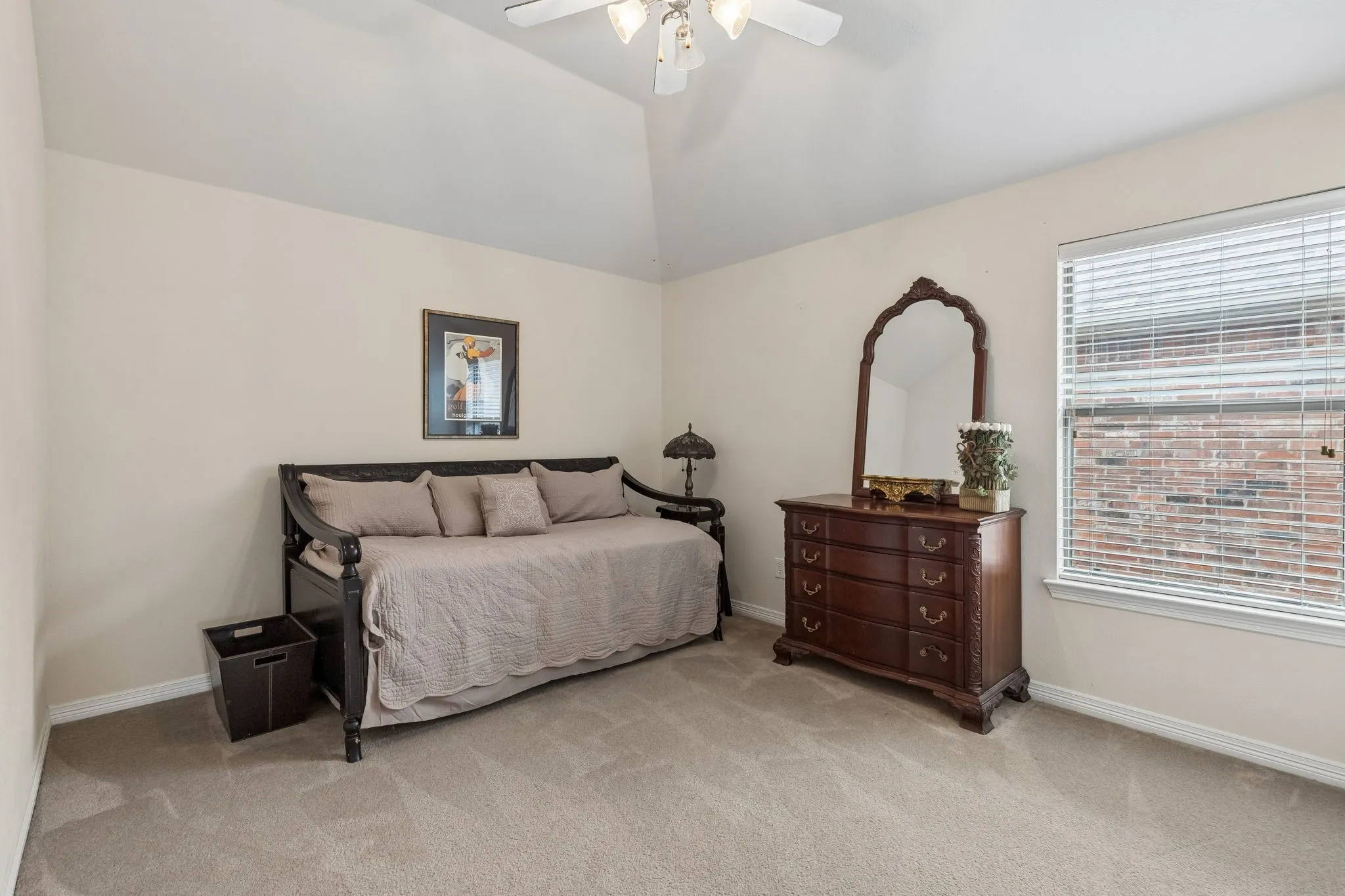 Vaulted ceiling, ceiling fan, neutral wall color, carpeted flooring, window with blinds