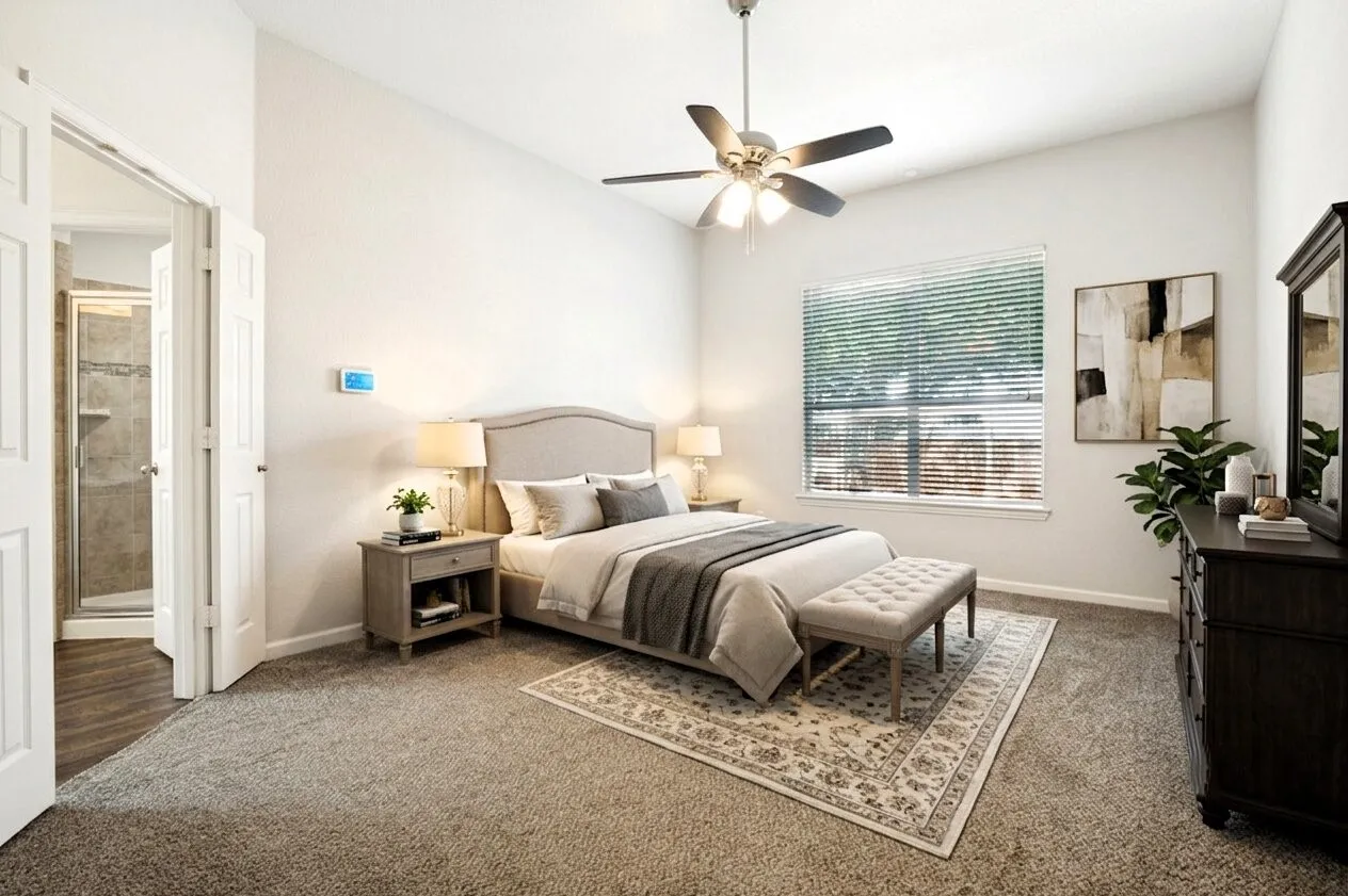 Carpeted room with a ceiling fan, window with blinds, and a doorway opening to a bathroom with a glass-enclosed shower featuring tiled walls and wood-finish flooring
