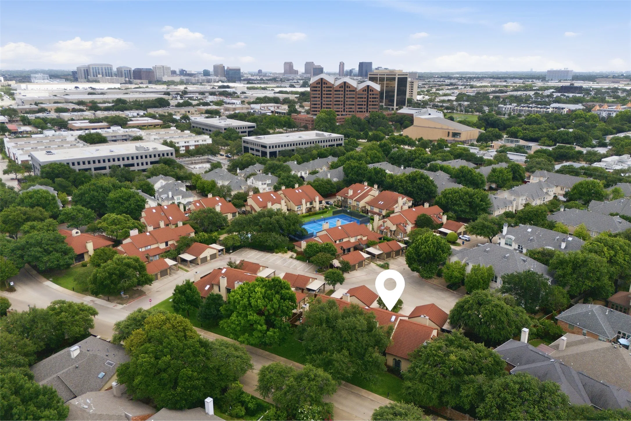 La Mirada with the unit location pinned, showing the community's tree-canopied layout, clay tile rooflines, on-site tennis court, and pool — all just minutes from Addison's dining and business corridor visible in the background