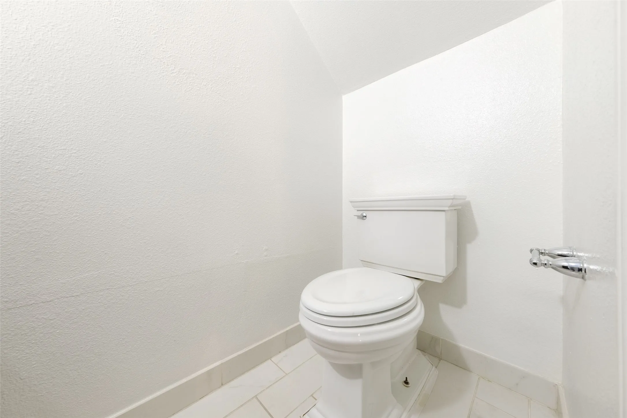 Updated half-bath with a white vessel sink, sleek chrome faucet, quartz countertop, and dark wood cabinetry — a modern, clean finish for guests.
