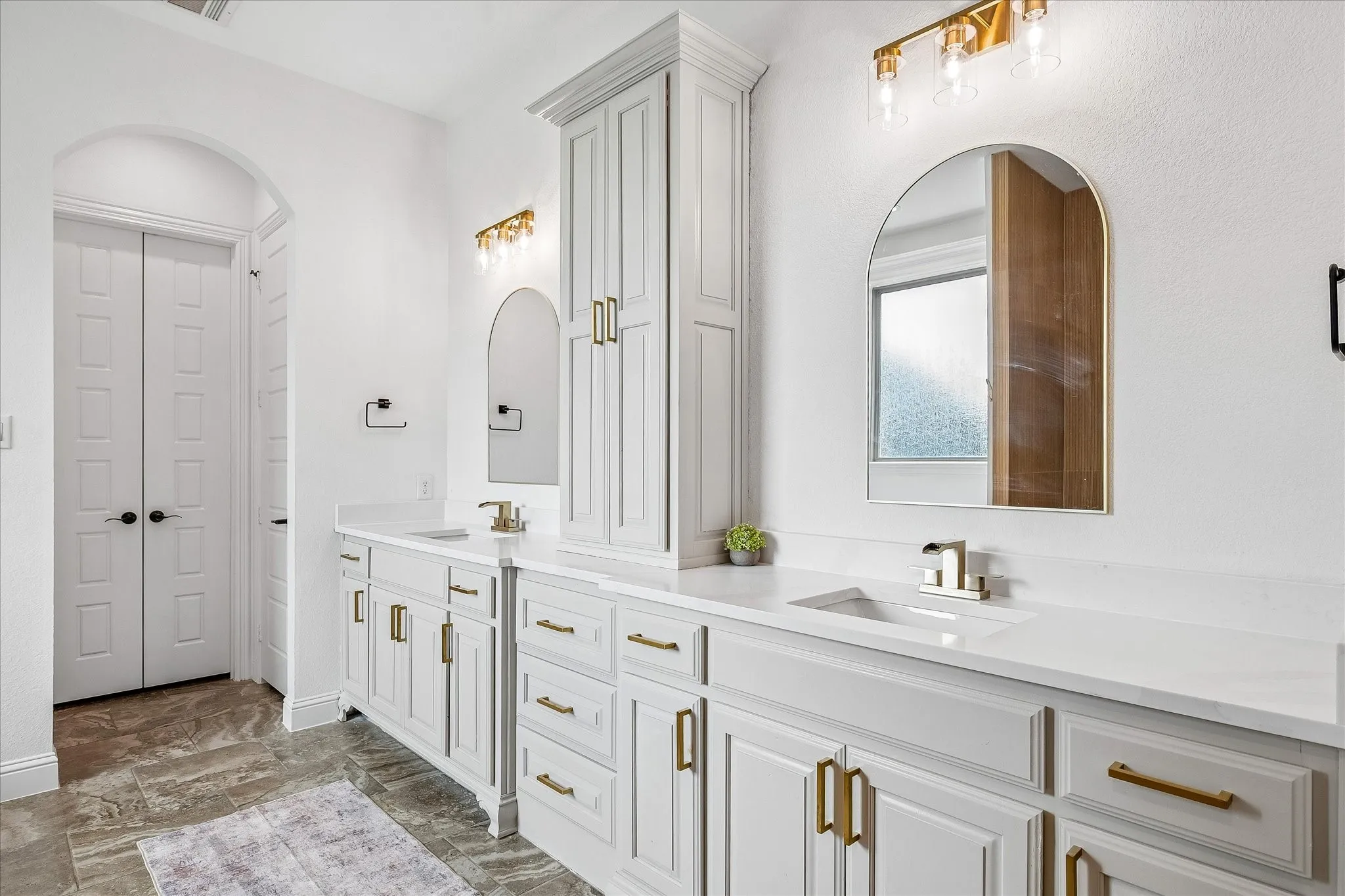 Updated bathroom with countertops, sinks, tub, shower and lighting!