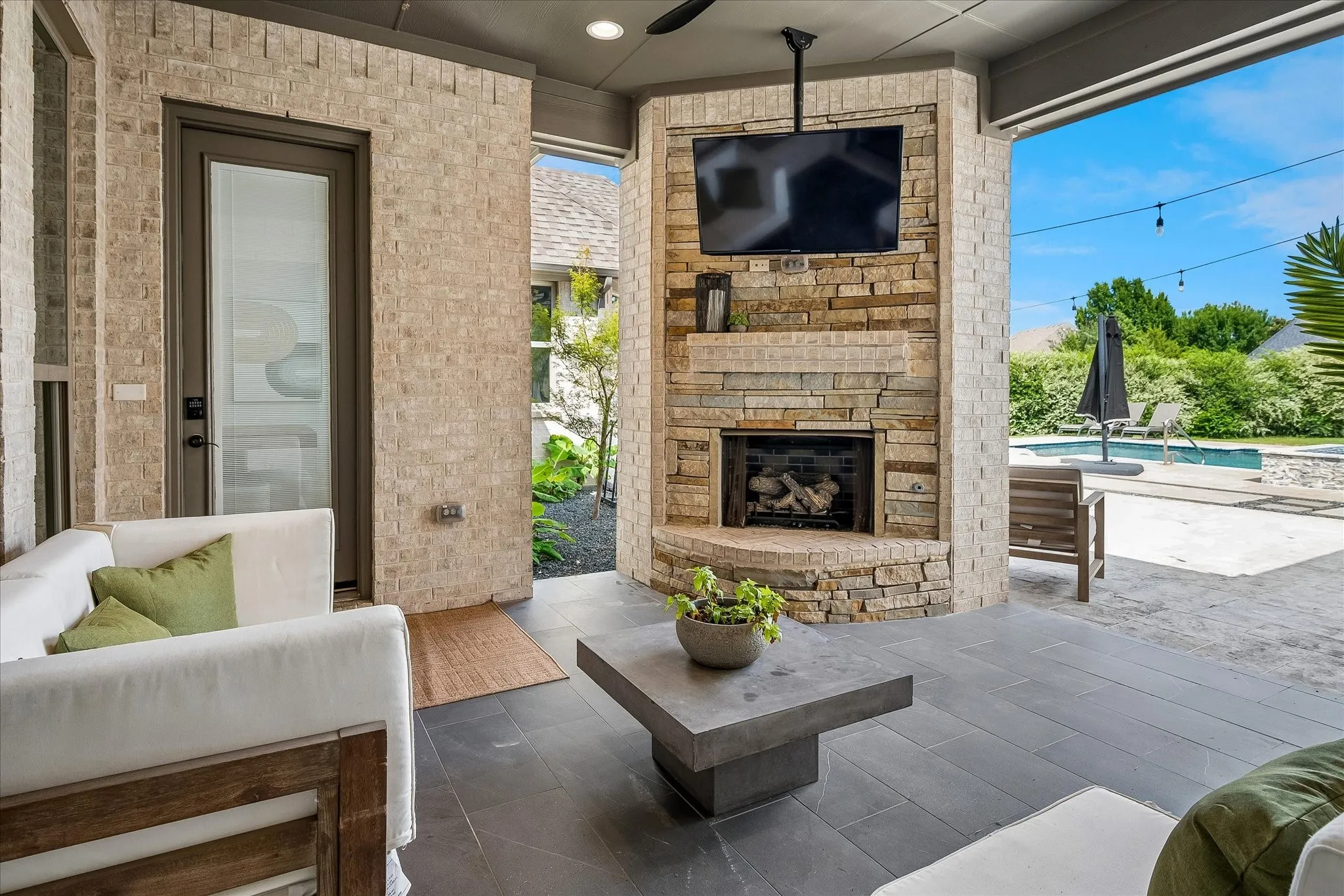 Covered patio has fireplace with gas logs