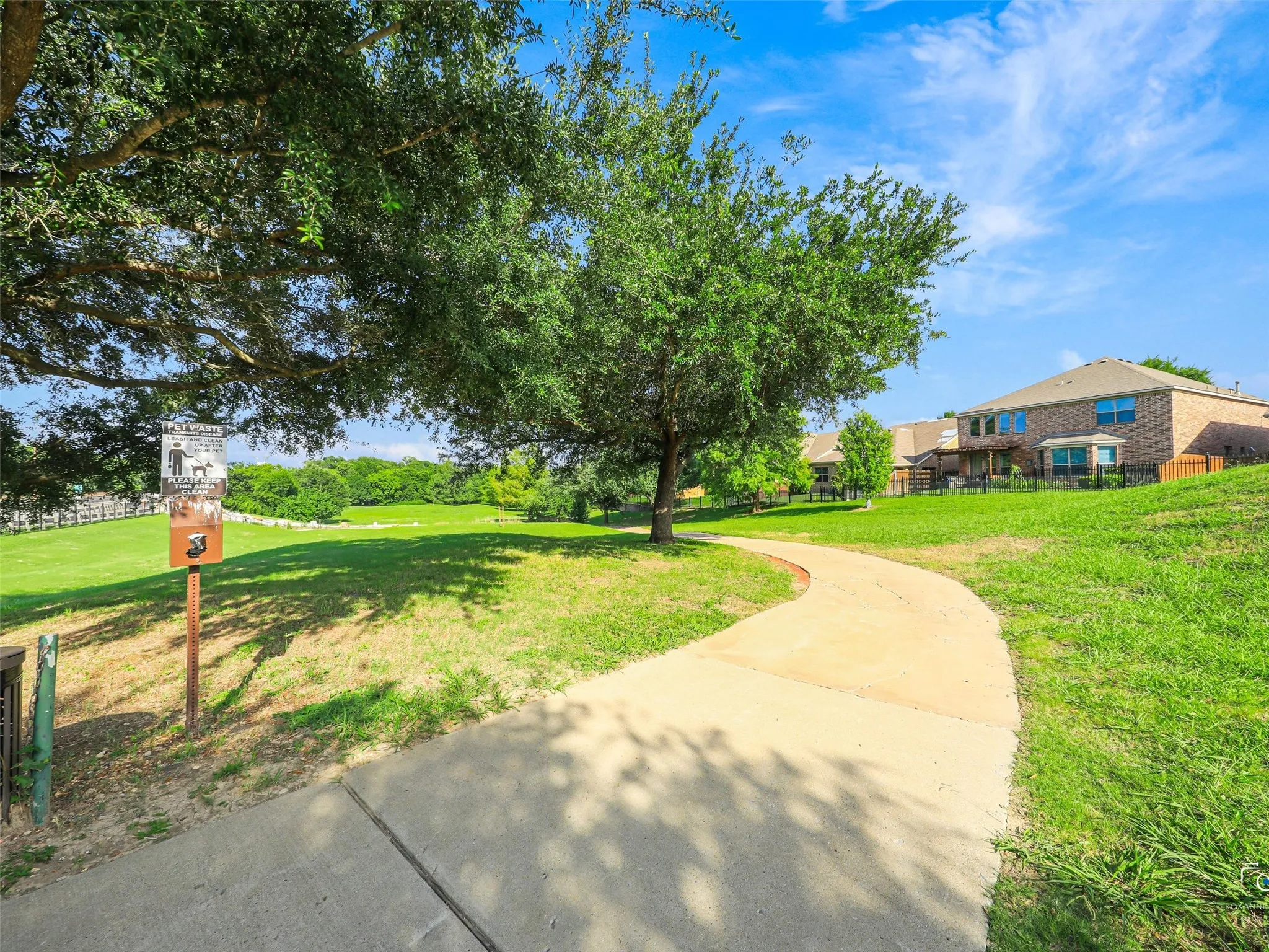 Community walking trails behind the home with direct gate access.
