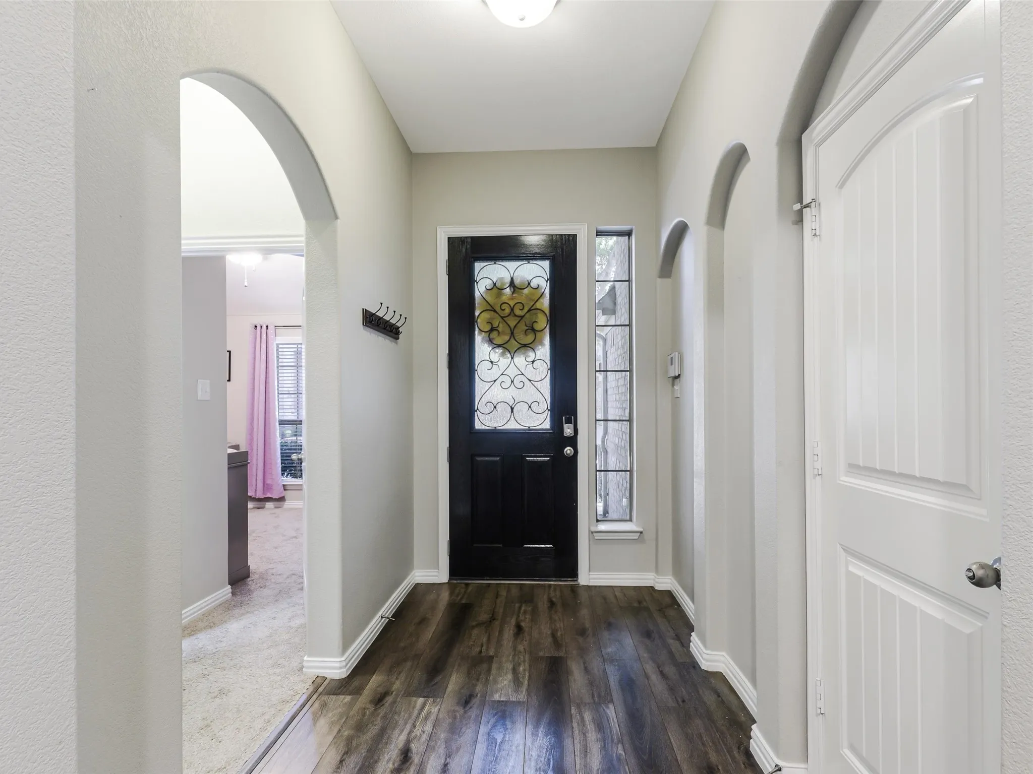 Entryway. Door to garage on right. The left side is the entrance to 2 bedrooms and a full bath.