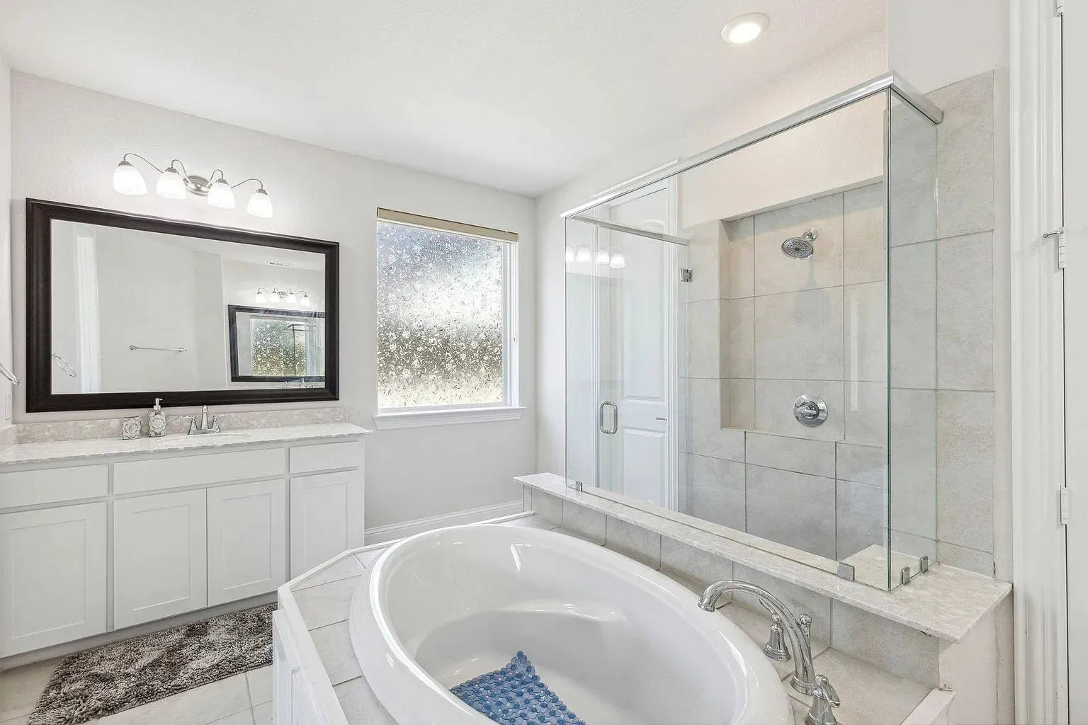 Freestanding soaking tub with a tiled surround
