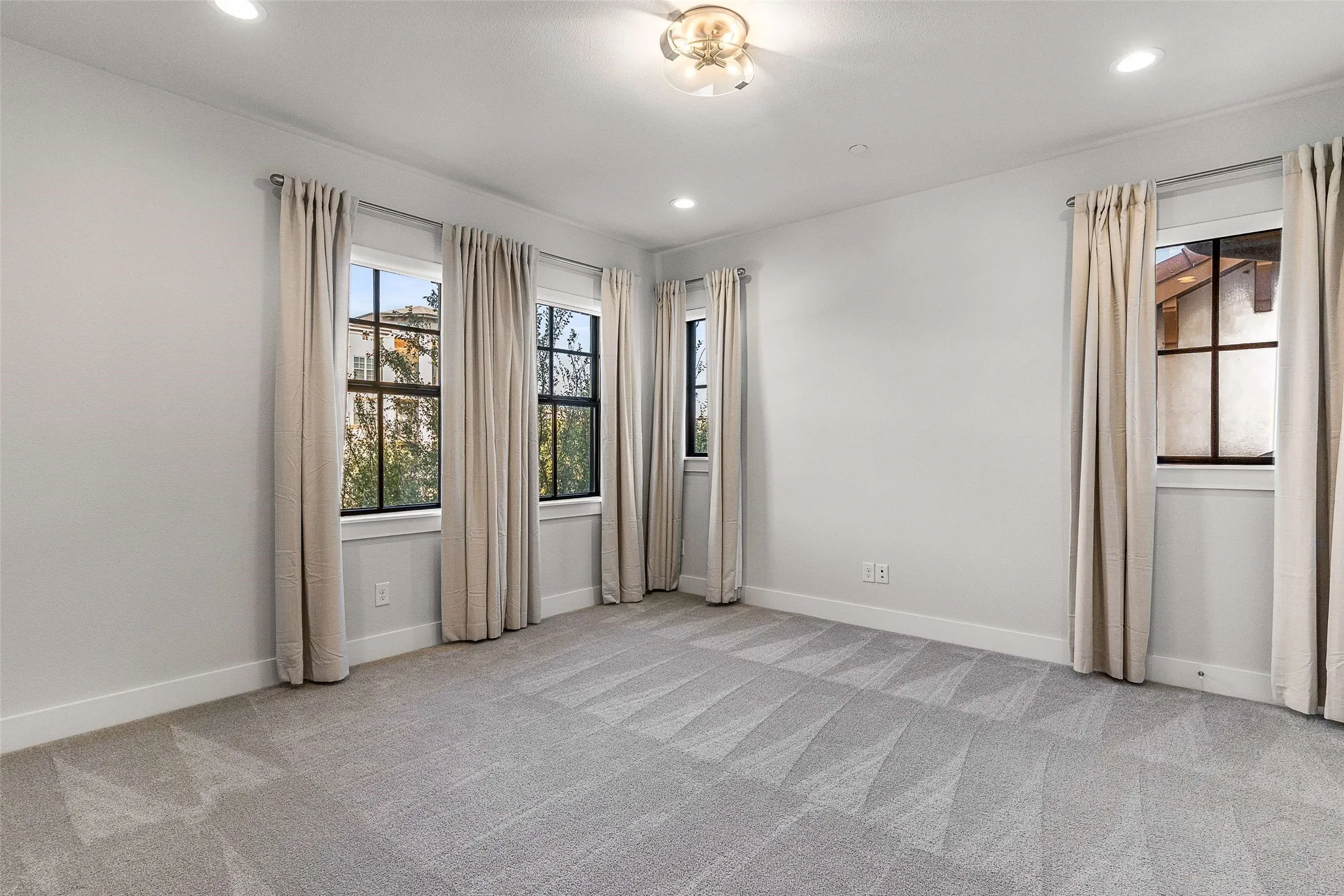 Room featuring neutral tone walls, recessed lighting, and a ceiling fan