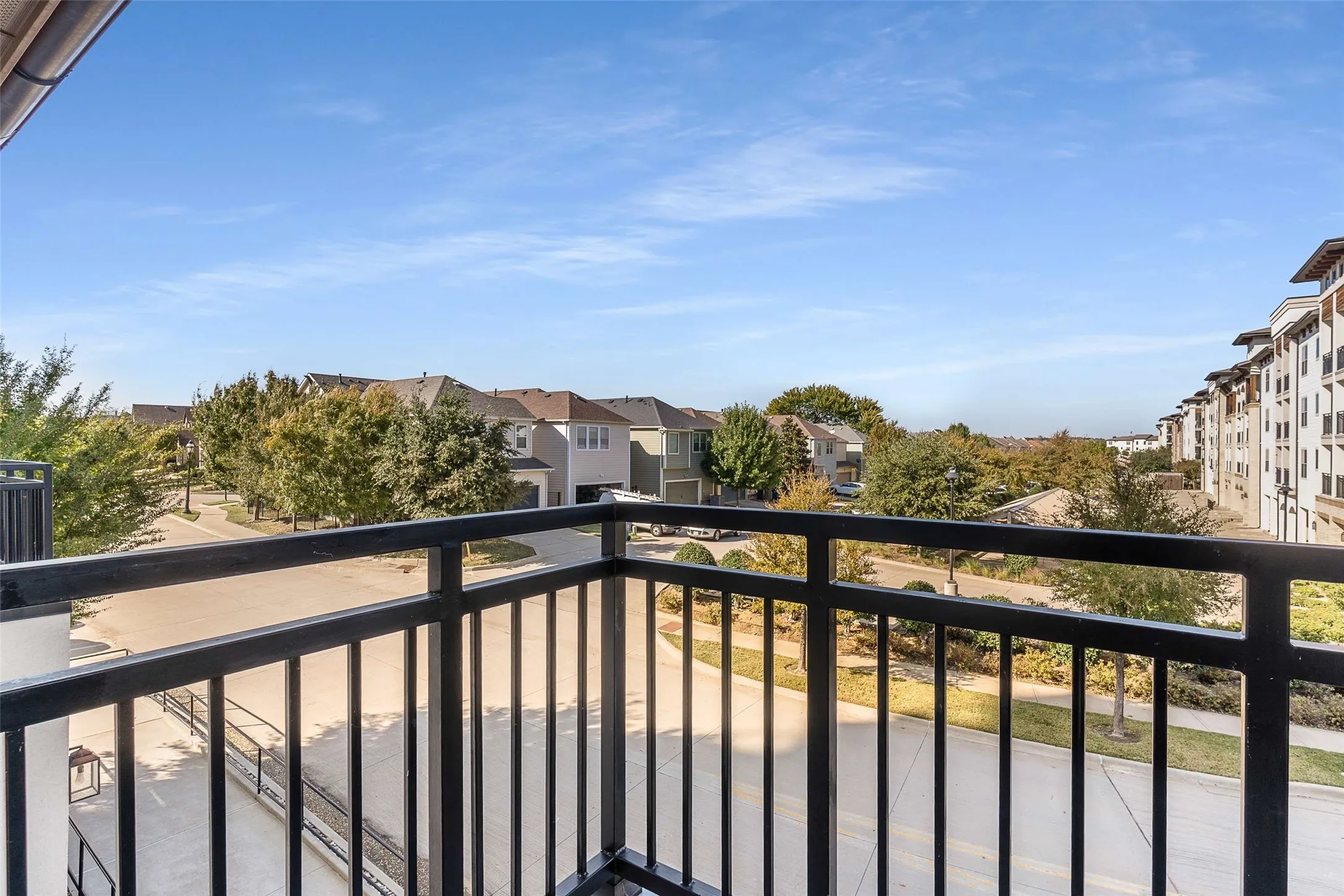Private balcony featuring black metal railings
