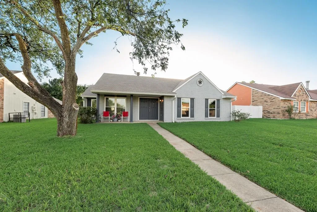 Single-story residence featuring a gray exterior with a contrasting dark gray front door