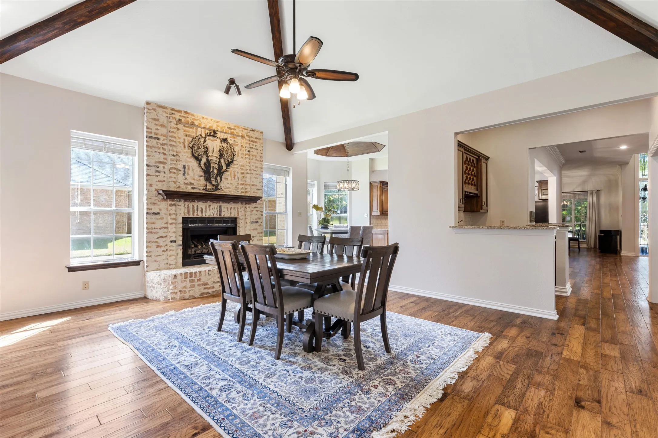 Living Room 2 currently being used as a dining area. Brick fireplace.