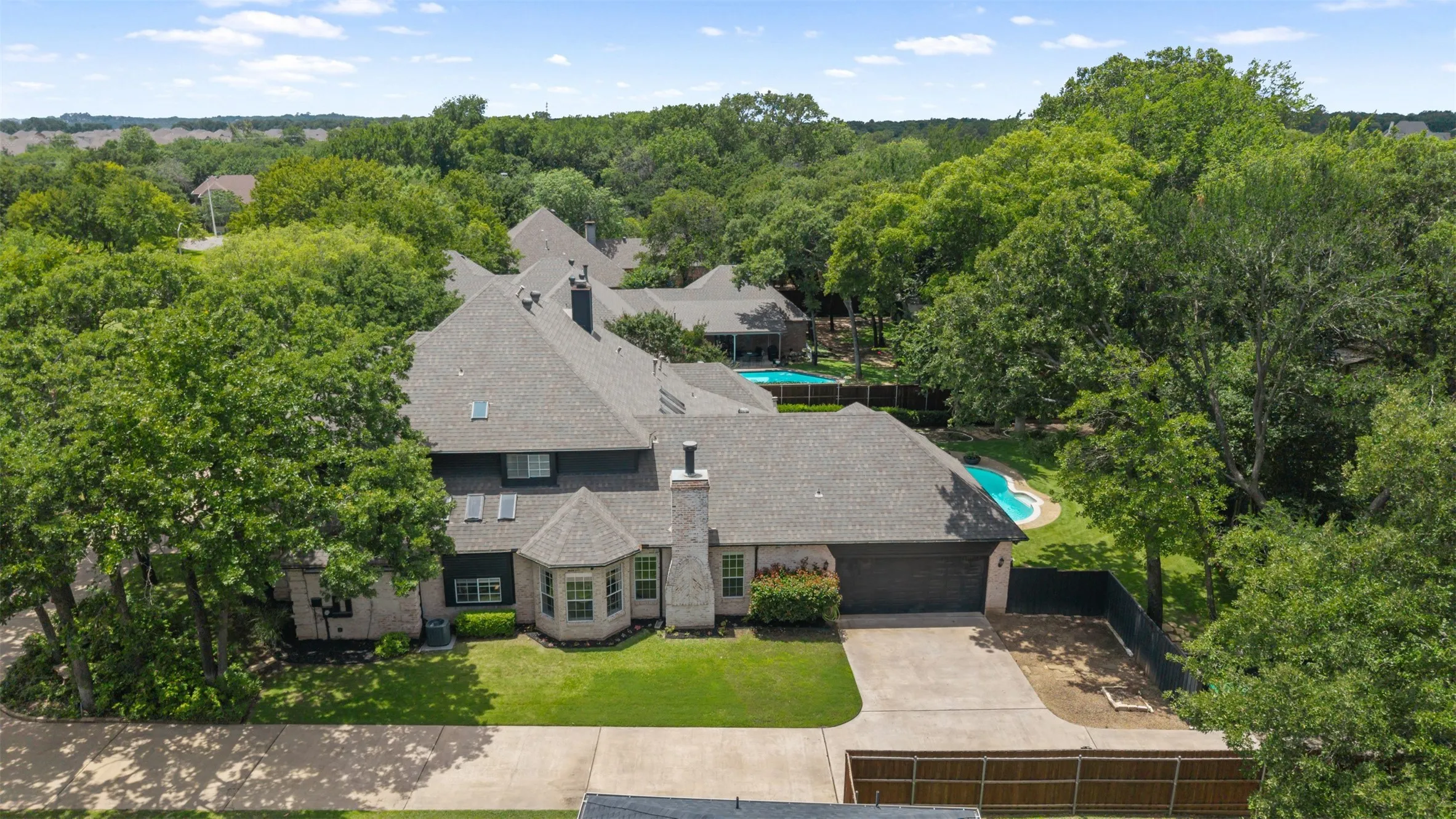 Side view of home with long driveway and 2 car garage.