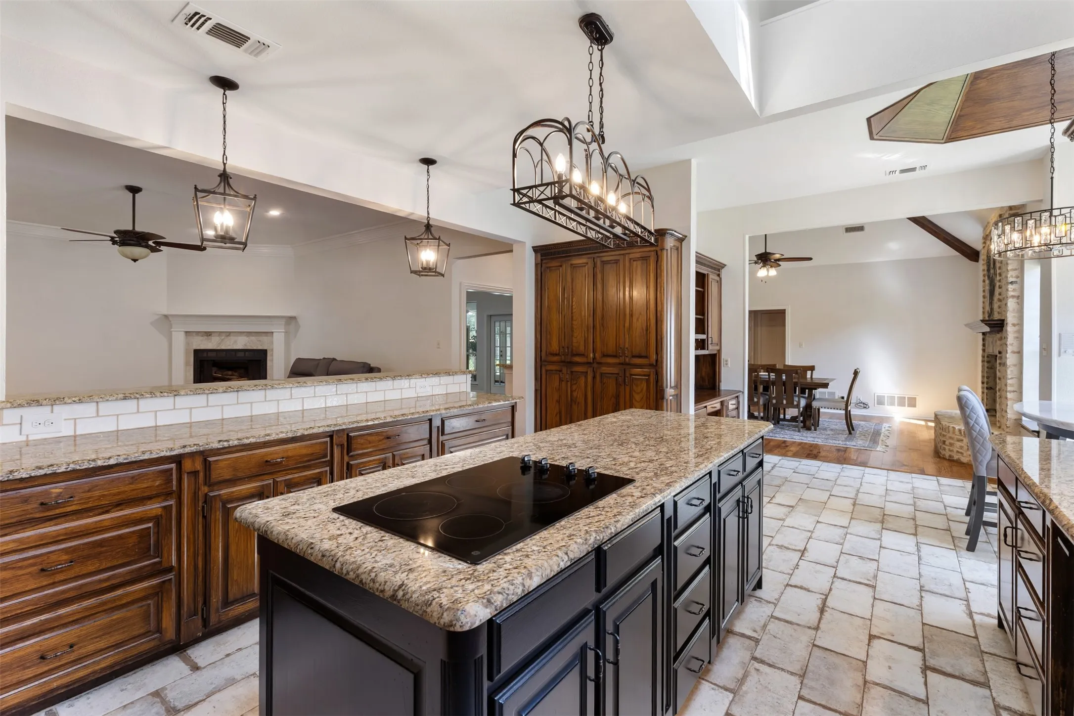 Huge center island with electric cooktop, plus long breakfast bar.