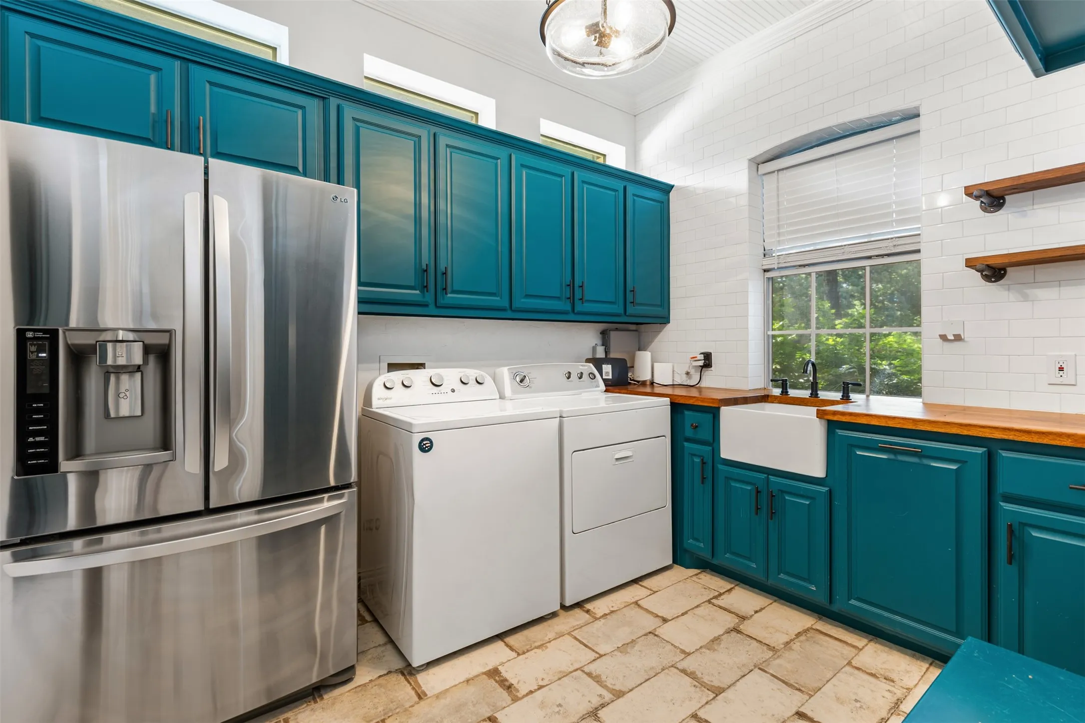 Custom Utility Room with space for full size w-d, refrigerator, sink, tons of storage & mudroom bench.
