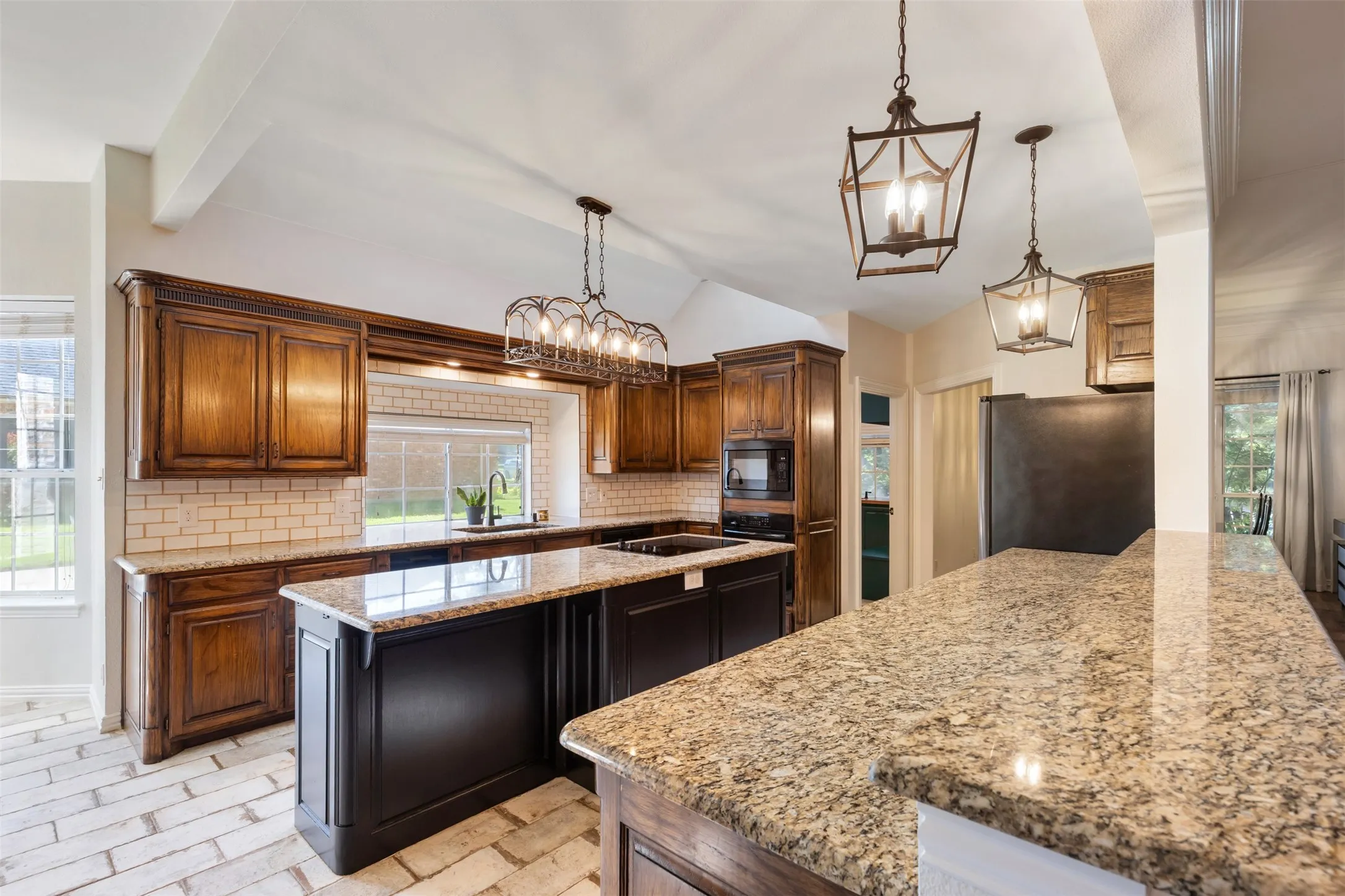 Gourmet Chef's Kitchen with abundant granite counters, cabinets, island and light filled.