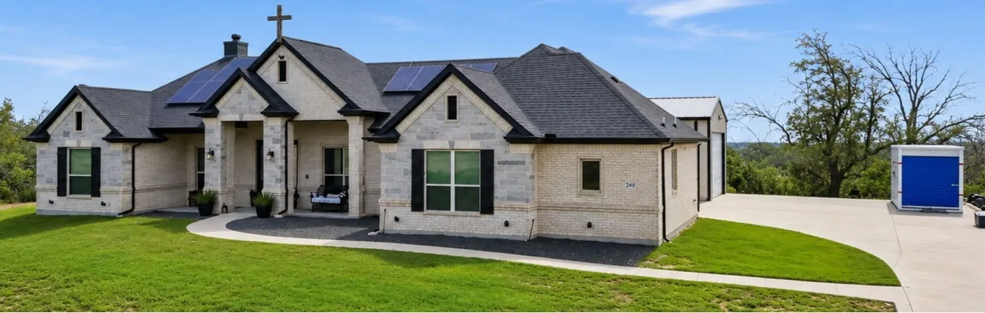 “A custom-built masterpiece with timeless stone and brick detailing and an expansive front patio perfect for enjoying the hilltop breeze.”