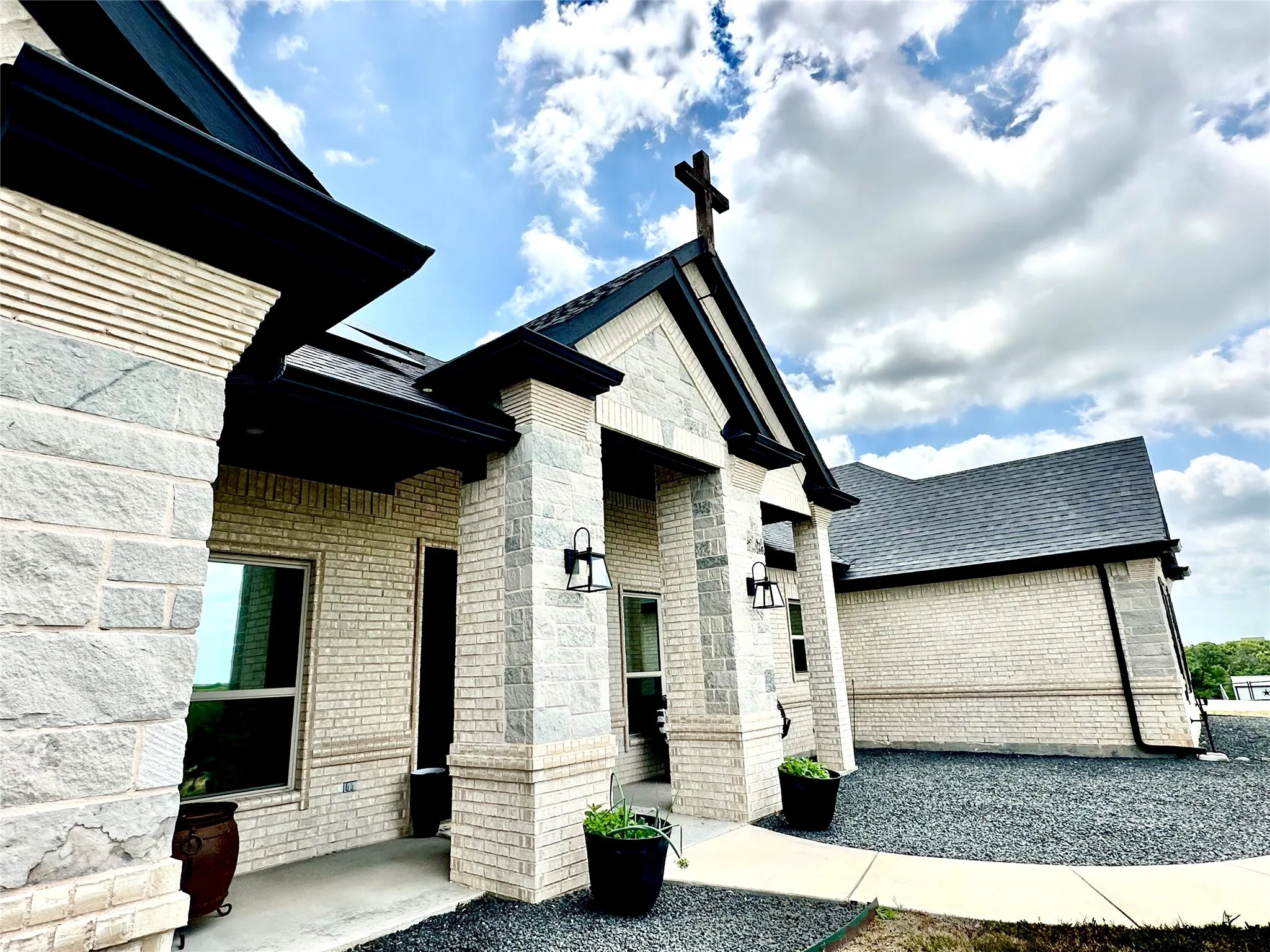 “A spacious, open-air front patio designed for presence, elegance, and unforgettable first impressions.”