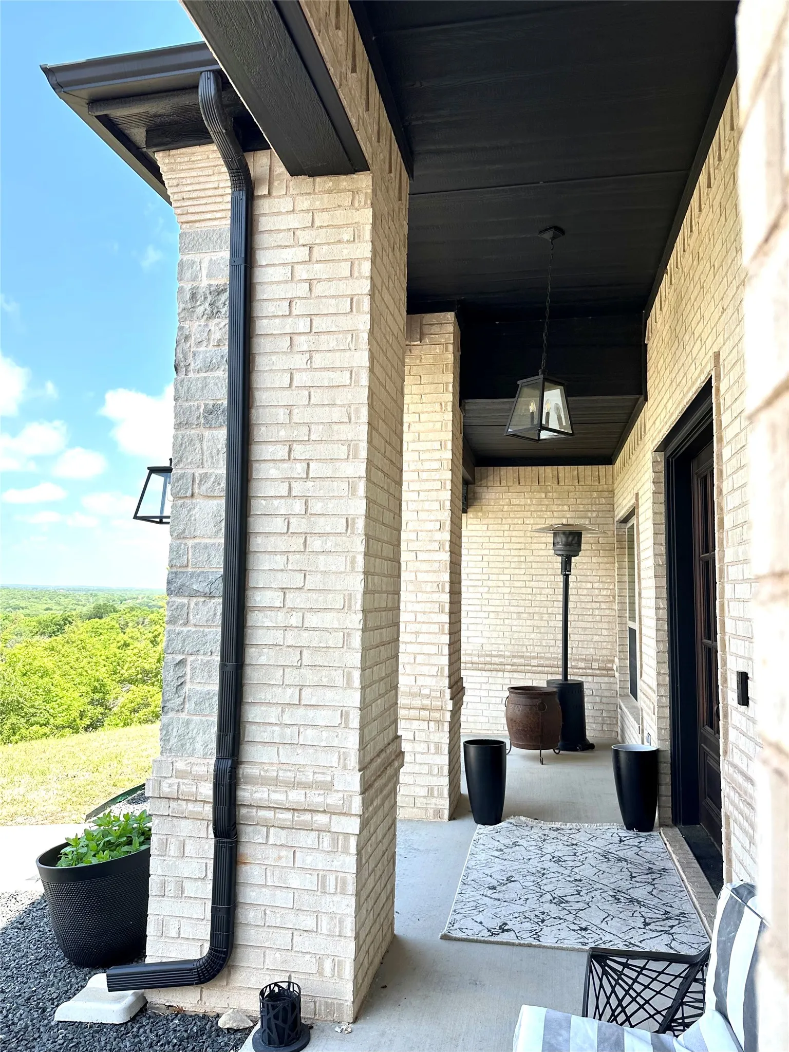 “An impressive, estate-style front patio with towering columns that make a statement from the moment you arrive.”
