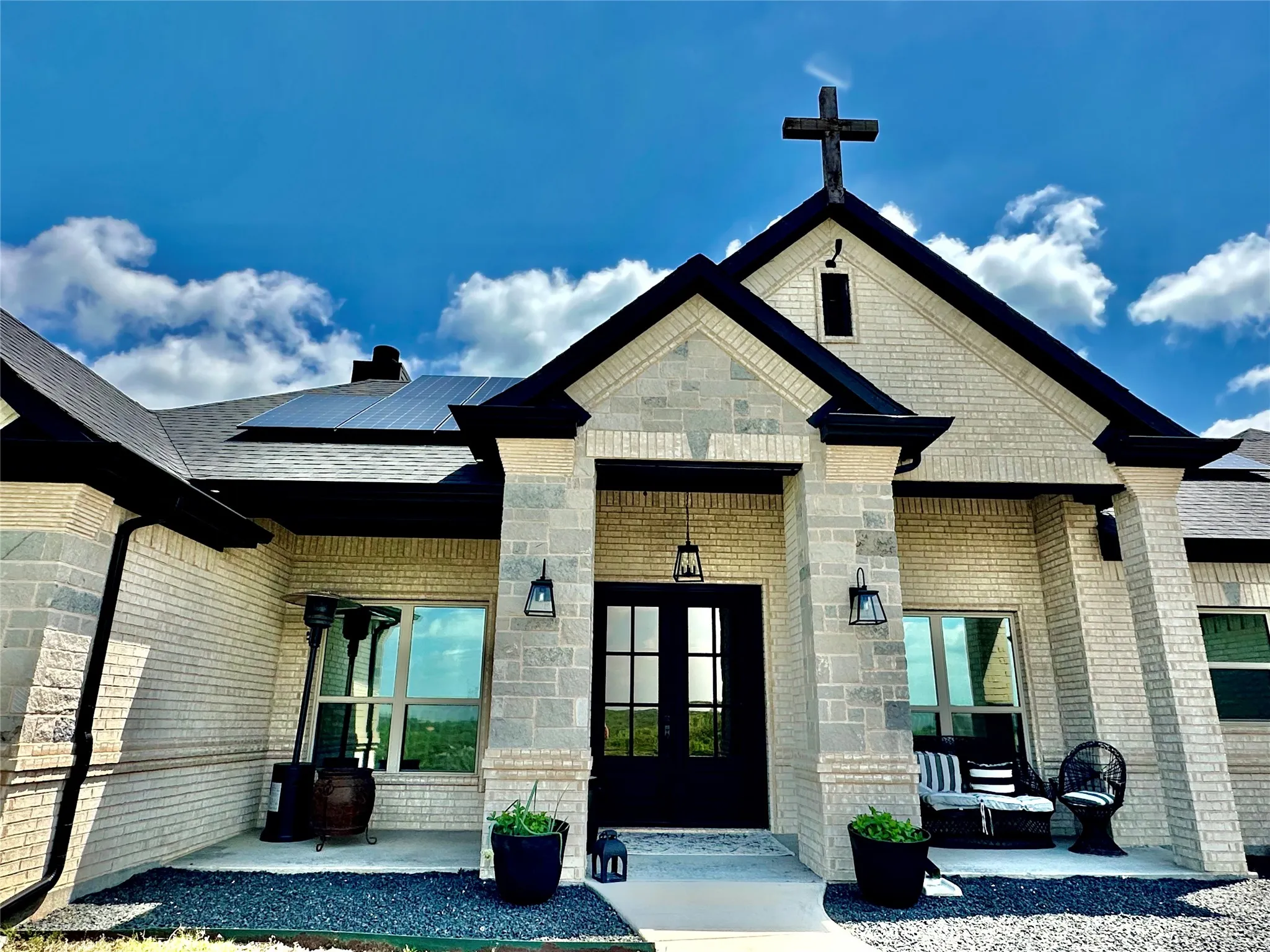 “Massive front patio with dramatic pillars that elevate the entire façade.”