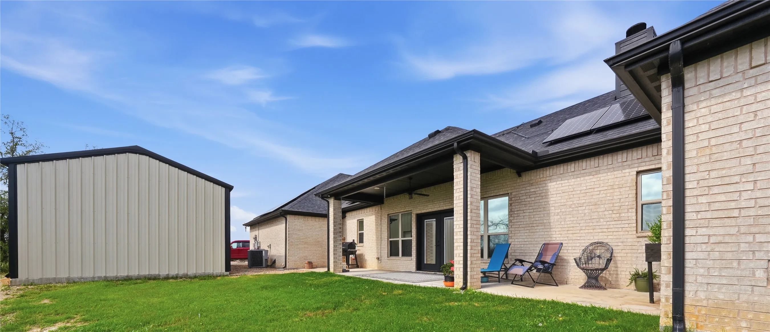 “A spacious, open back patio offering peaceful hilltop breezes and lovely elevated views.”