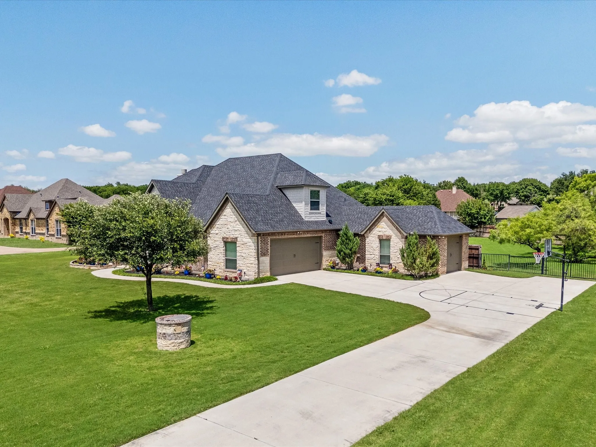 Beautifully updated custom home situated on a one-acre lot in Aurora Vista with mature landscaping, stone accents, and exceptional curb appeal.