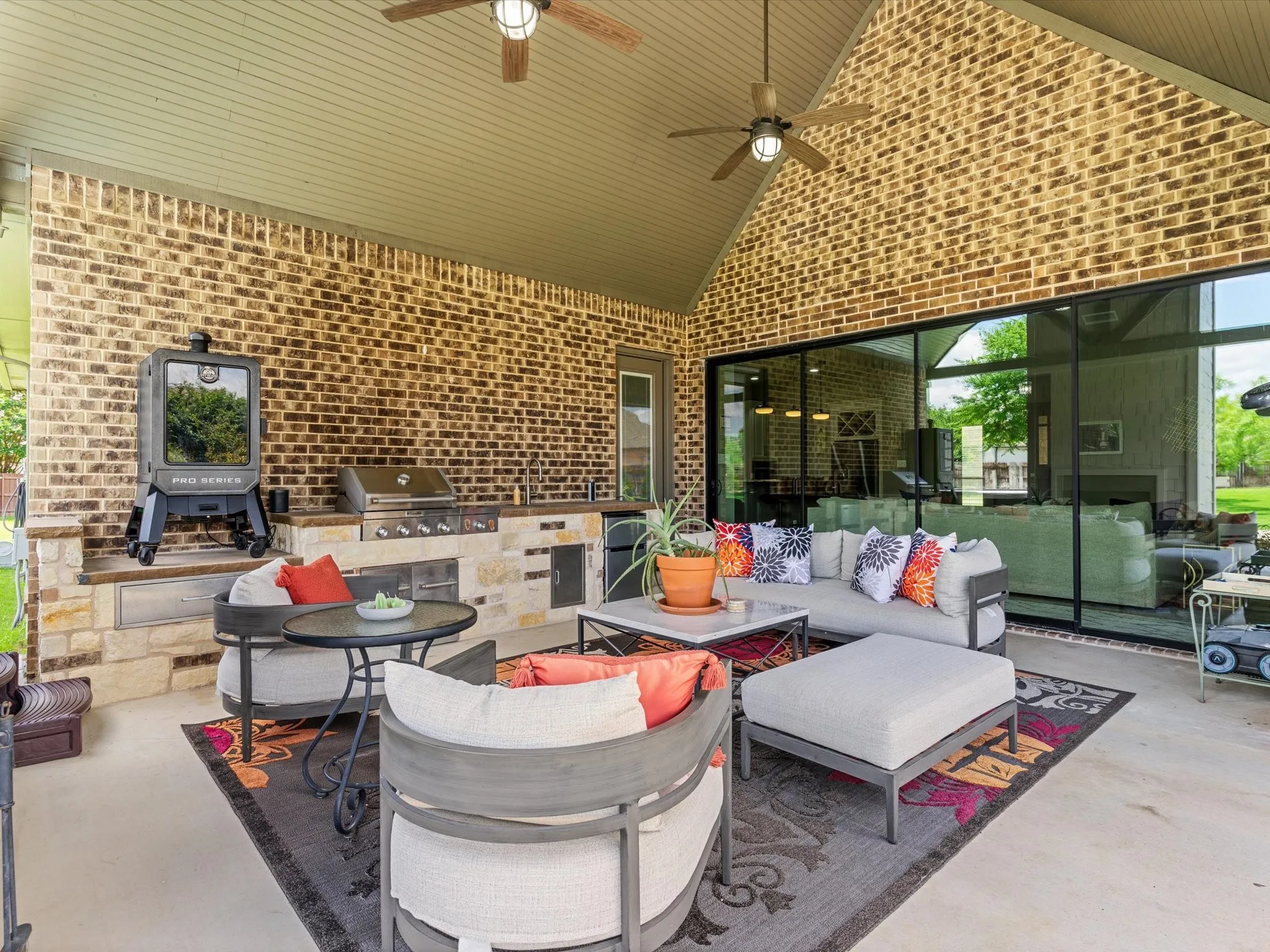 Covered outdoor living area overlooking the pool and backyard oasis.