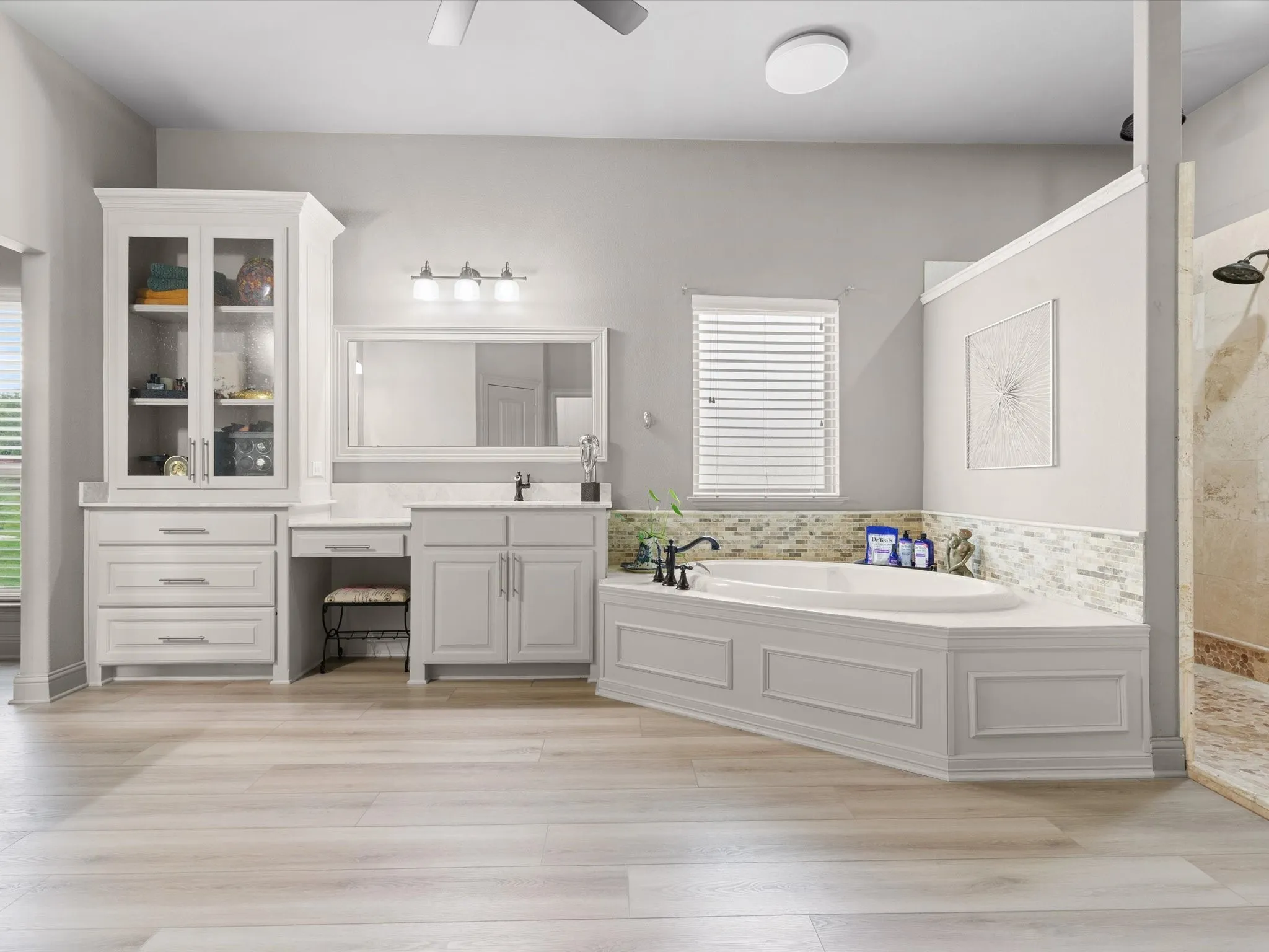 Well-appointed primary bath with dual vanities, soaking tub, and separate shower.
