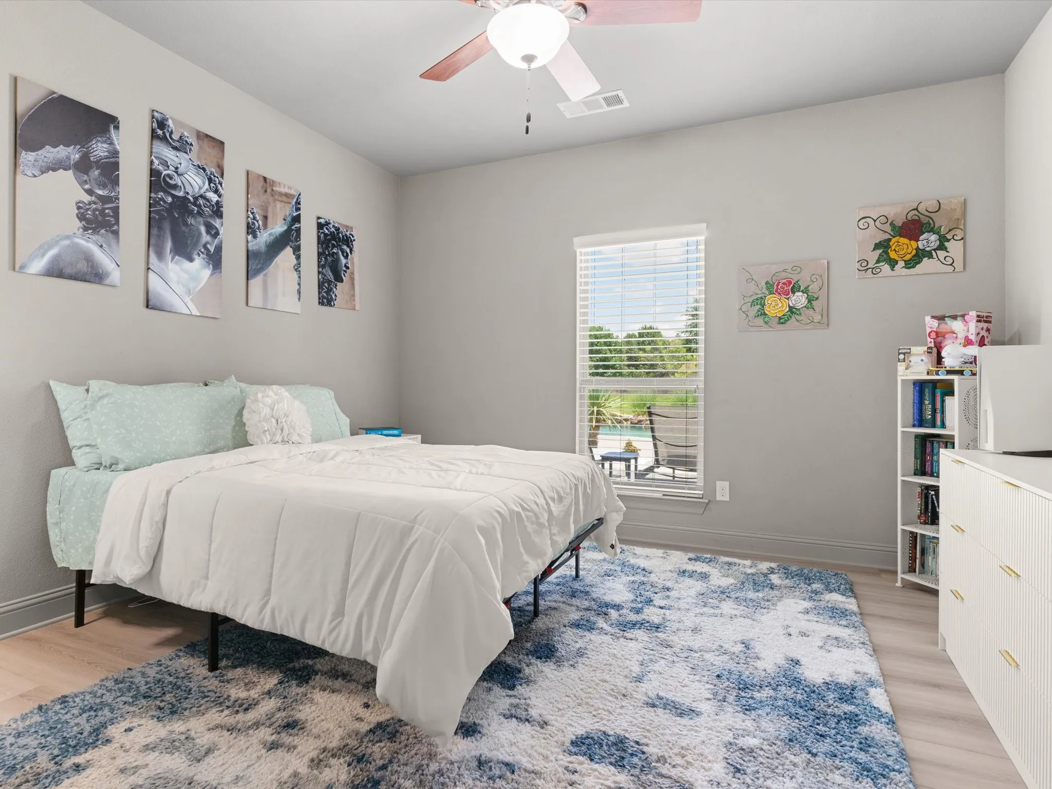 Comfortable secondary bedroom with updated lighting and ample closet space.