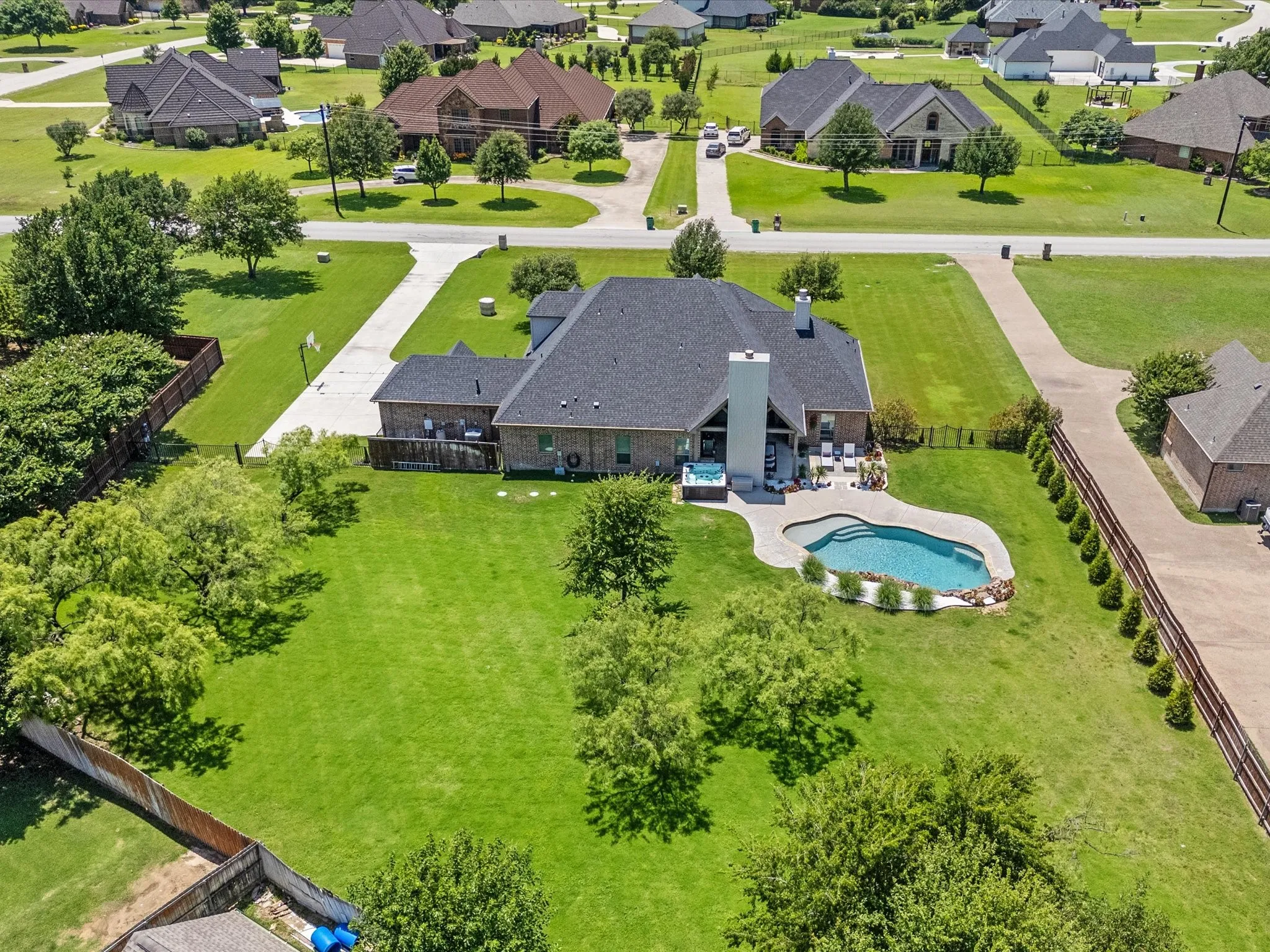 Beautifully updated custom home situated on a one-acre lot in Aurora Vista with mature landscaping, stone accents, and exceptional curb appeal.