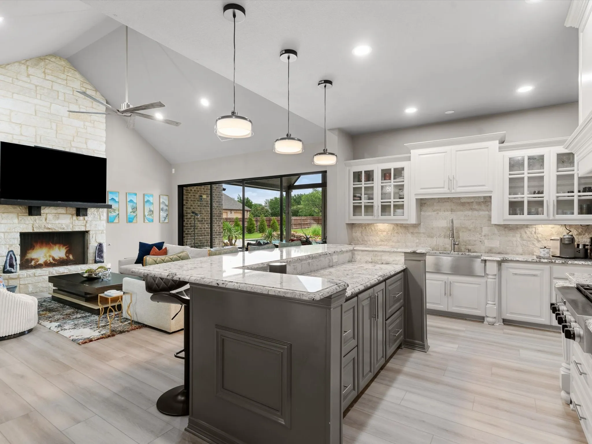 Updated kitchen with ample cabinetry, modern hardware, generous counter space, and views of the backyard