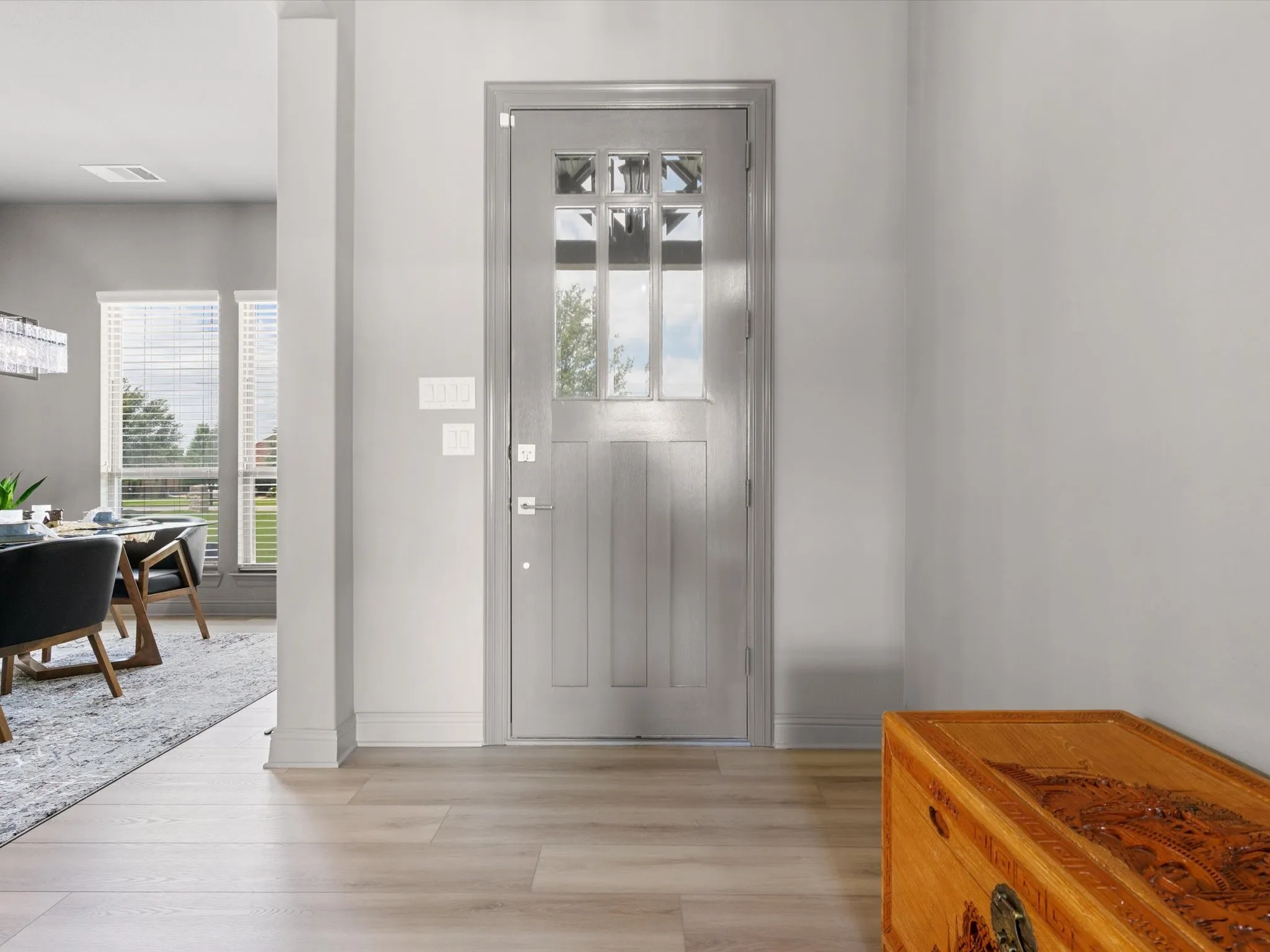 Welcoming entry with updated lighting, fresh paint, and views into the open-concept living spaces.
