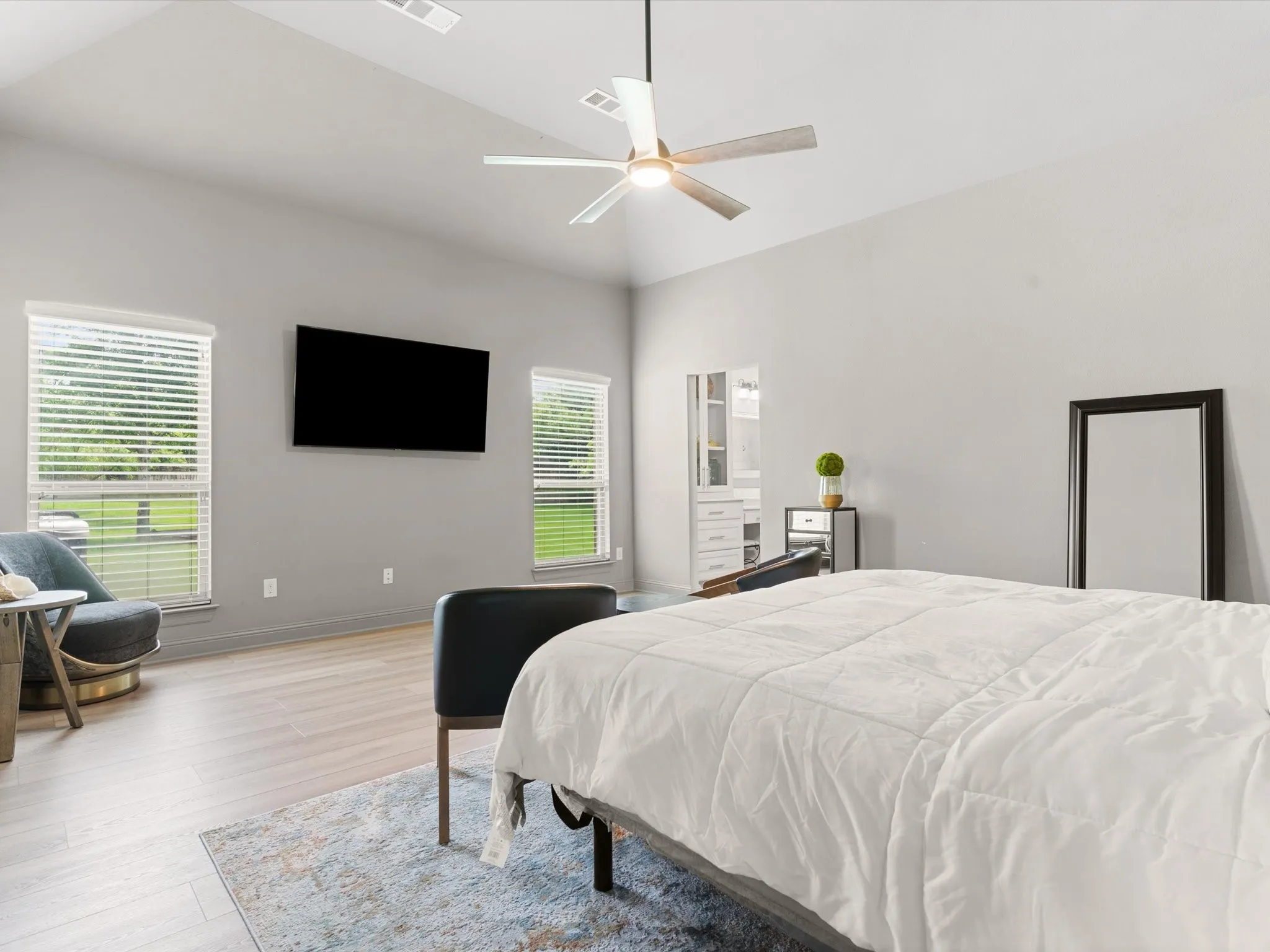 Private primary suite featuring generous square footage, natural light, and peaceful backyard views.