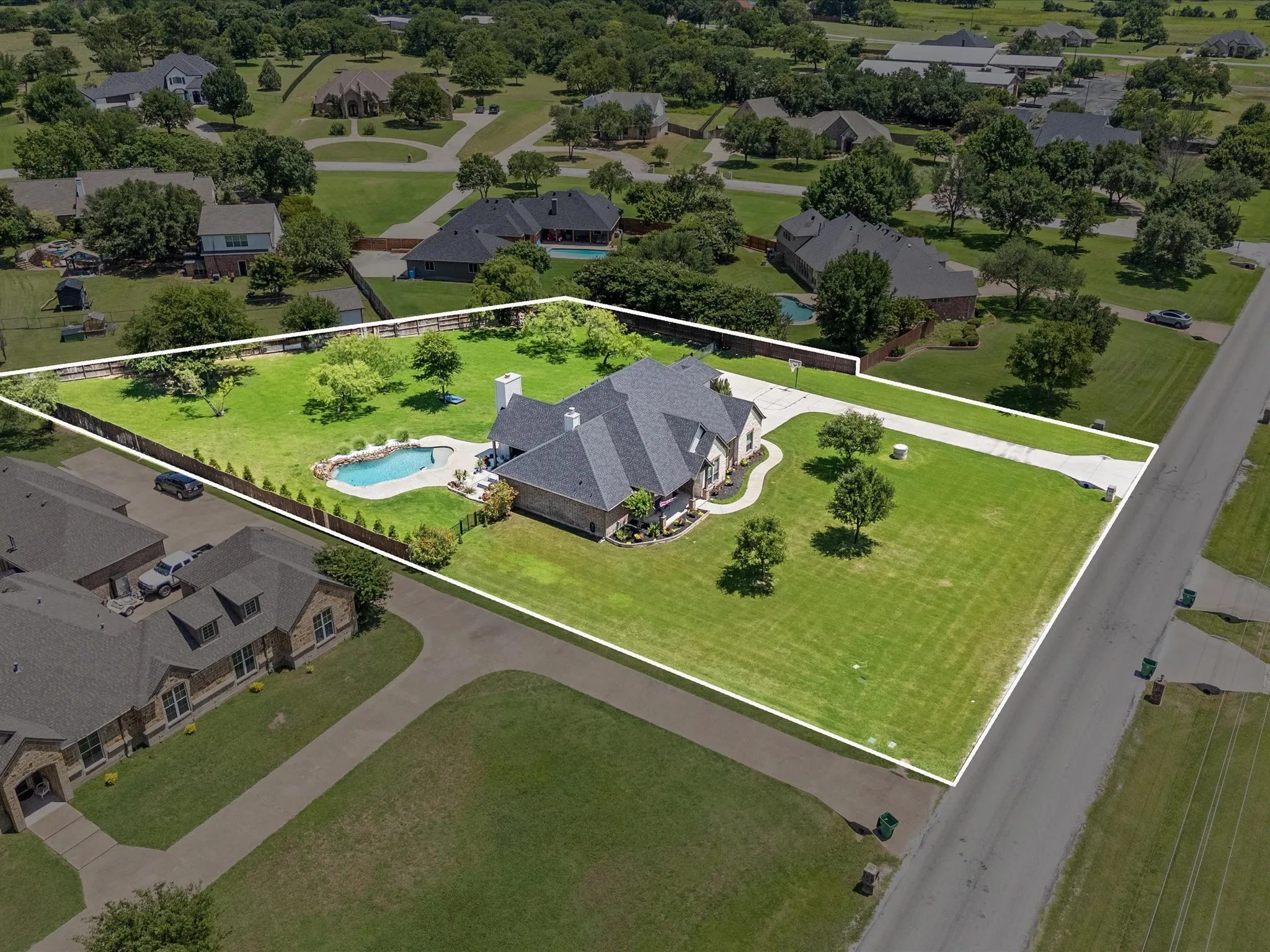 Beautifully updated custom home situated on a one-acre lot in Aurora Vista with mature landscaping, stone accents, and exceptional curb appeal.