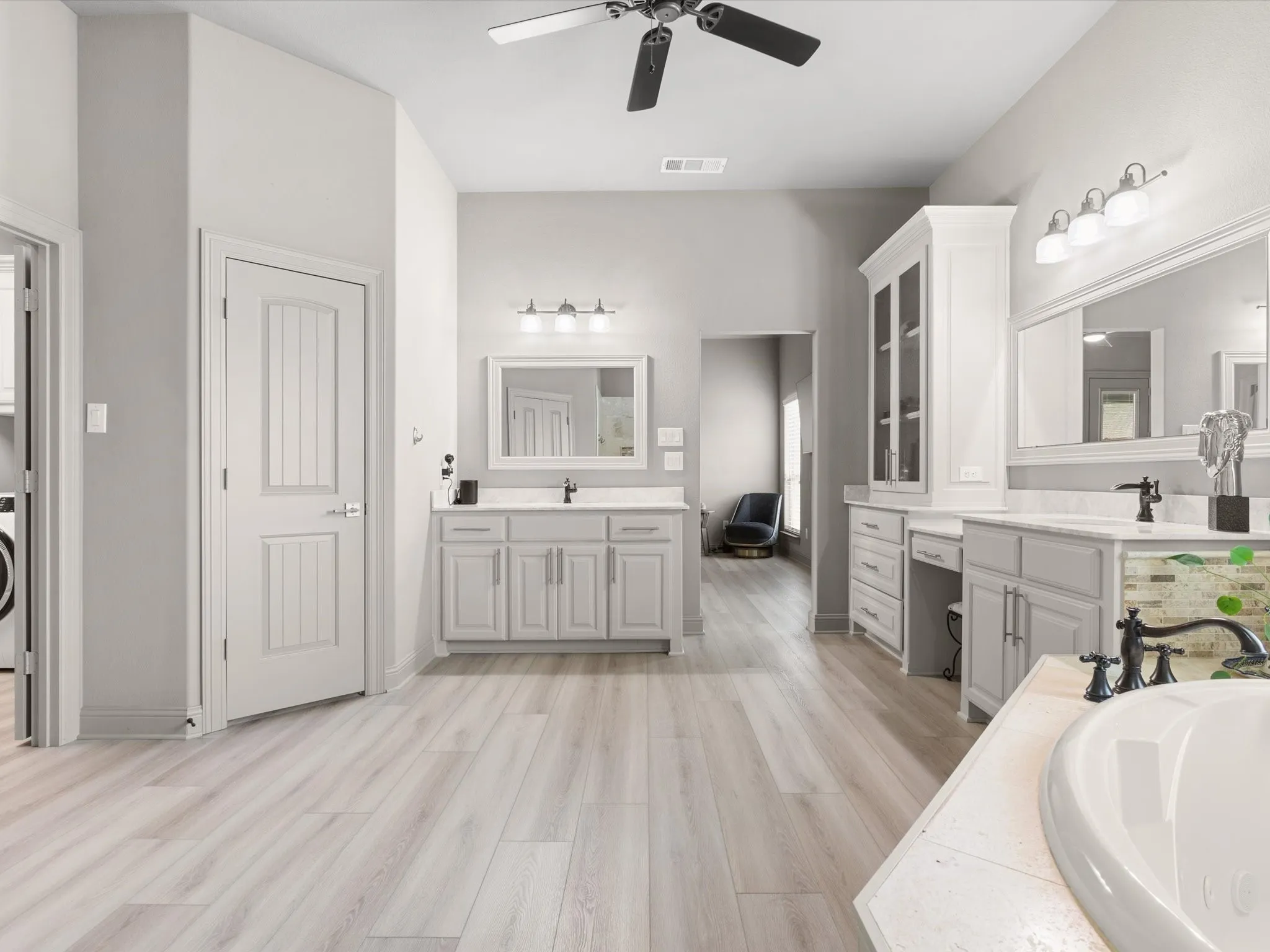 Well-appointed primary bath with dual vanities, soaking tub, and separate shower.