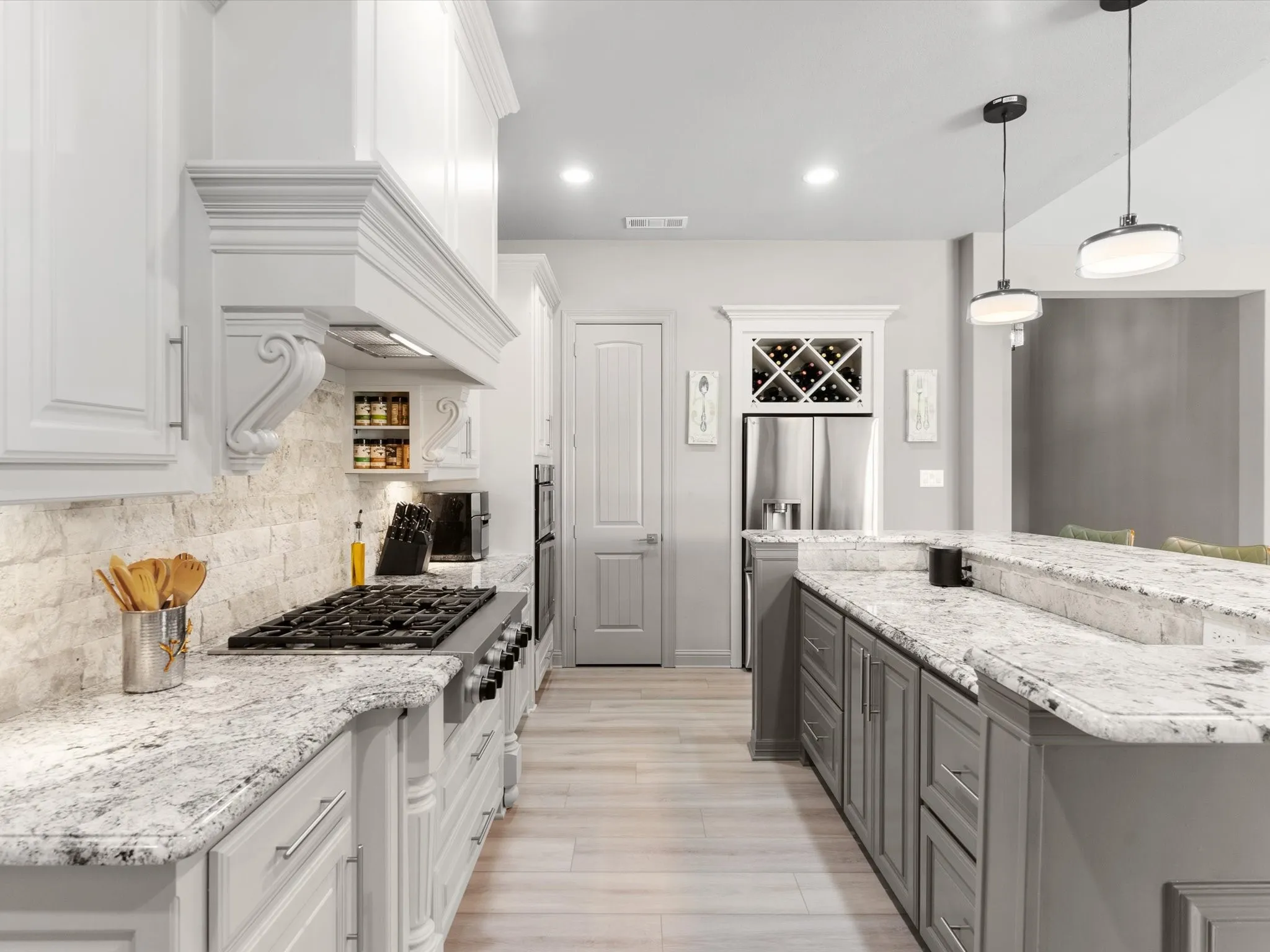 Updated kitchen with ample cabinetry, modern hardware, generous counter space, and views of the backyard