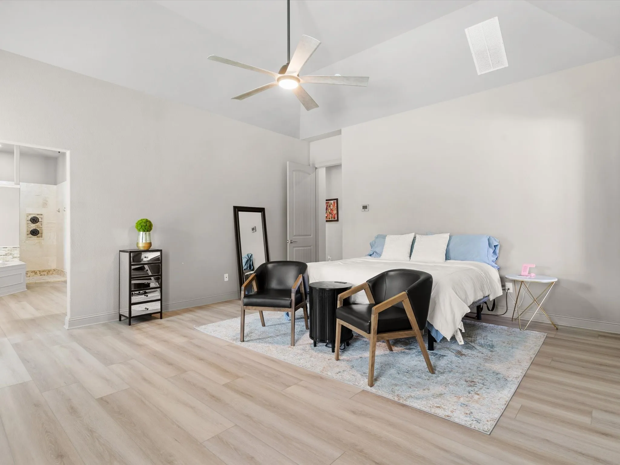 Private primary suite featuring generous square footage, natural light, and peaceful backyard views.